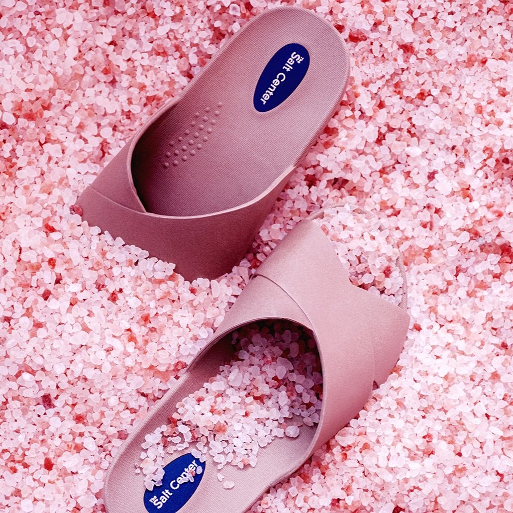 Pink Peace Love Salt sandals representing The Salt Center's community give-back program