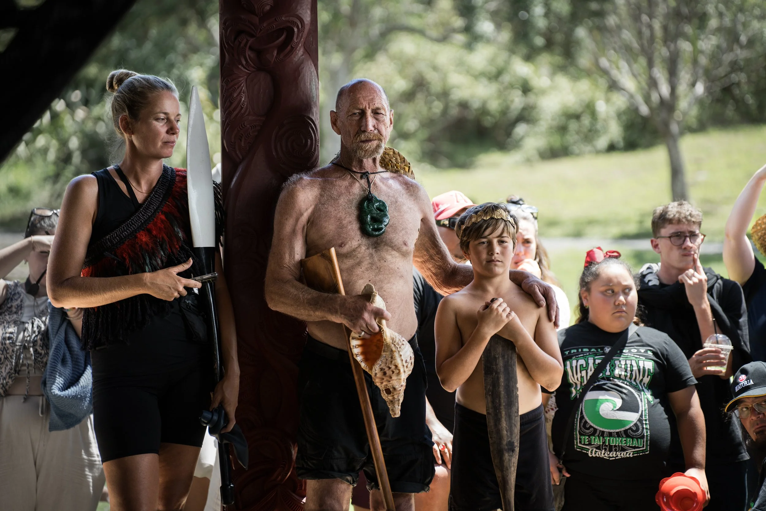 Paddlers from Ngātokimatawhaorua watch as a haka is performed.