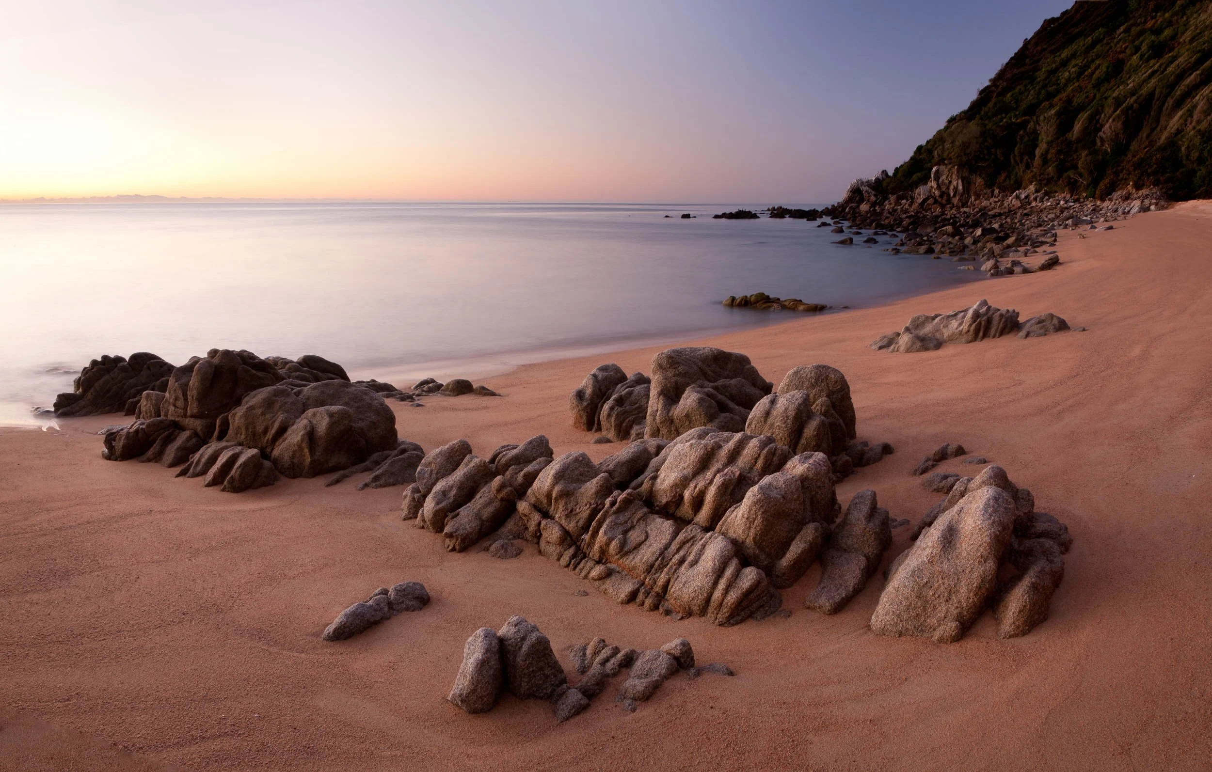 Rock formations on the beach at dusk, Whariwharangi Bay no.2.