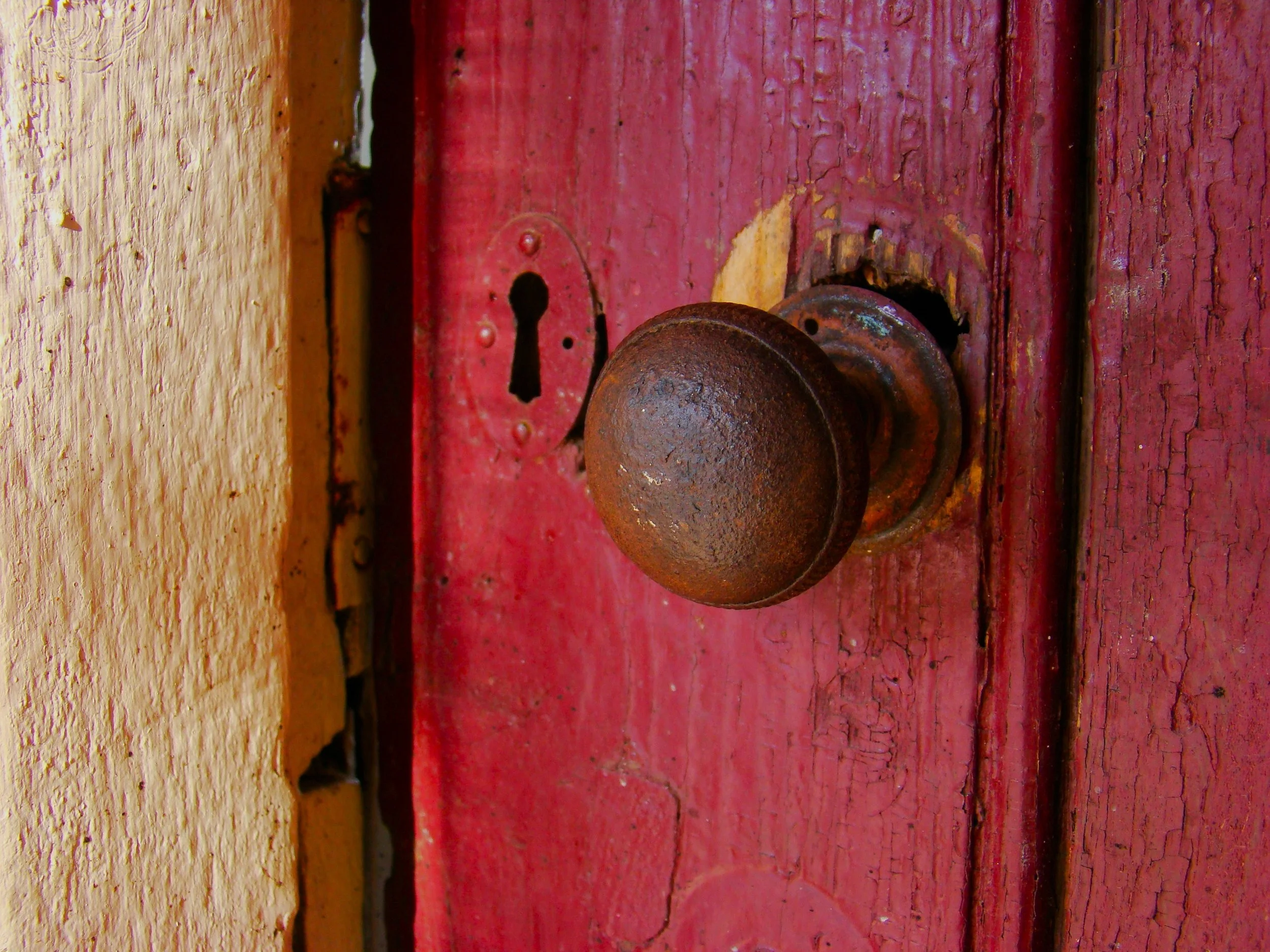 old red door with metal handle