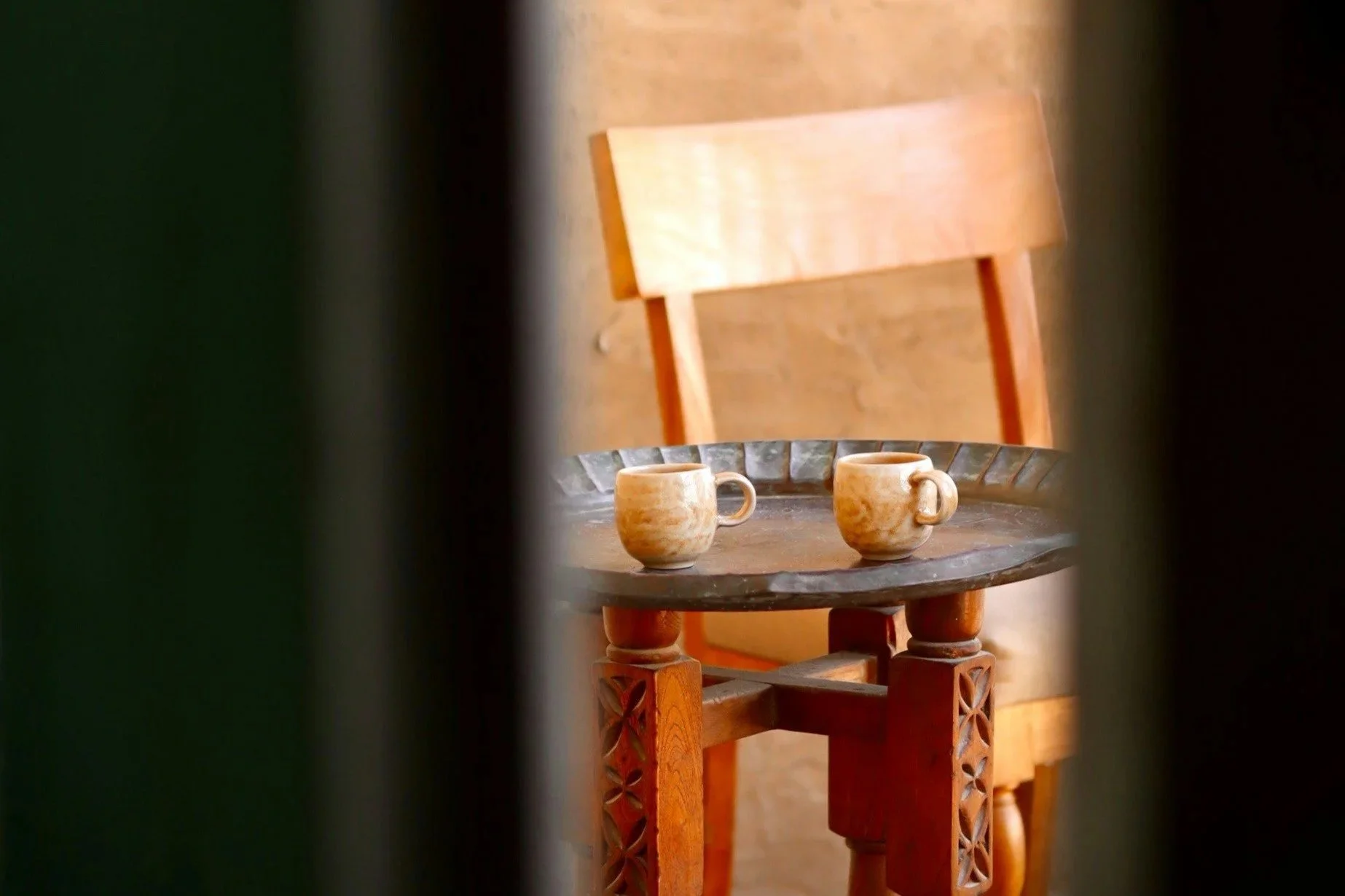 three hands holding coffee in a coffee shop