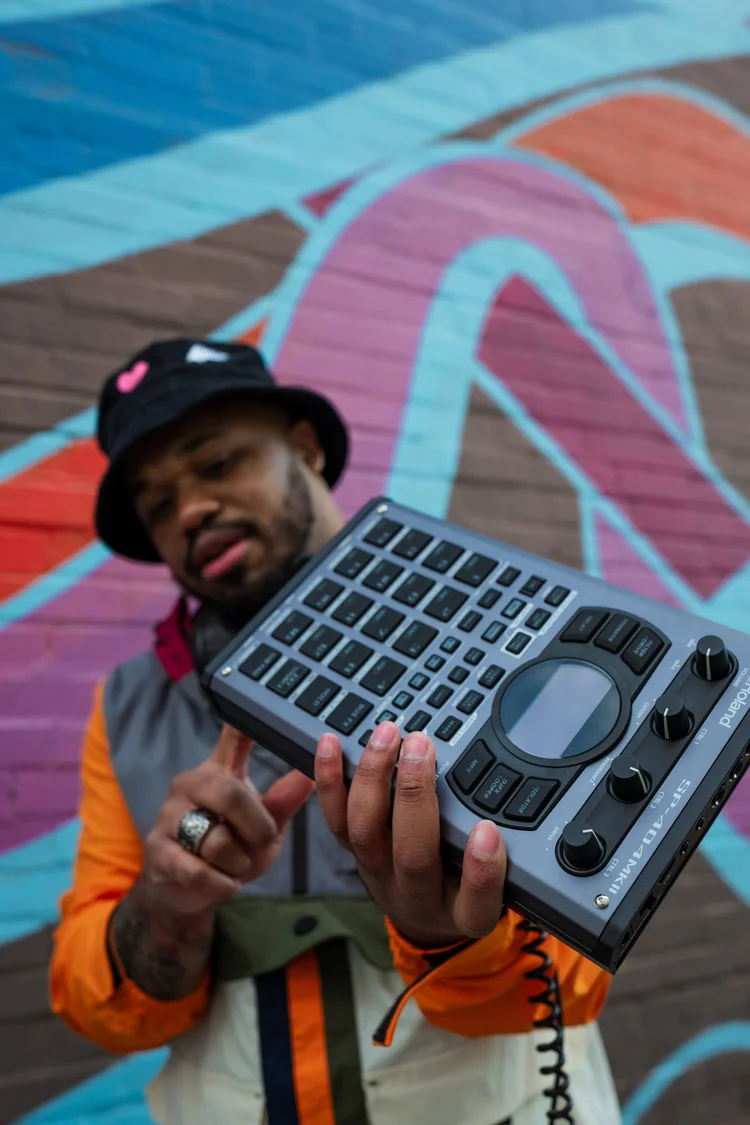 Heartspace Film music photograph: an artist with a sampler in front of a painted mural