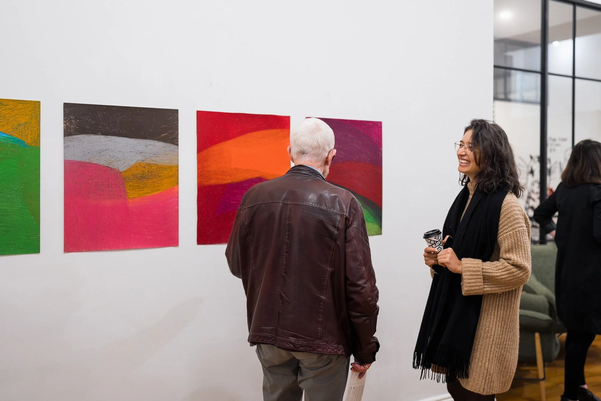 People observing an abstract drawing installation in an exhibition