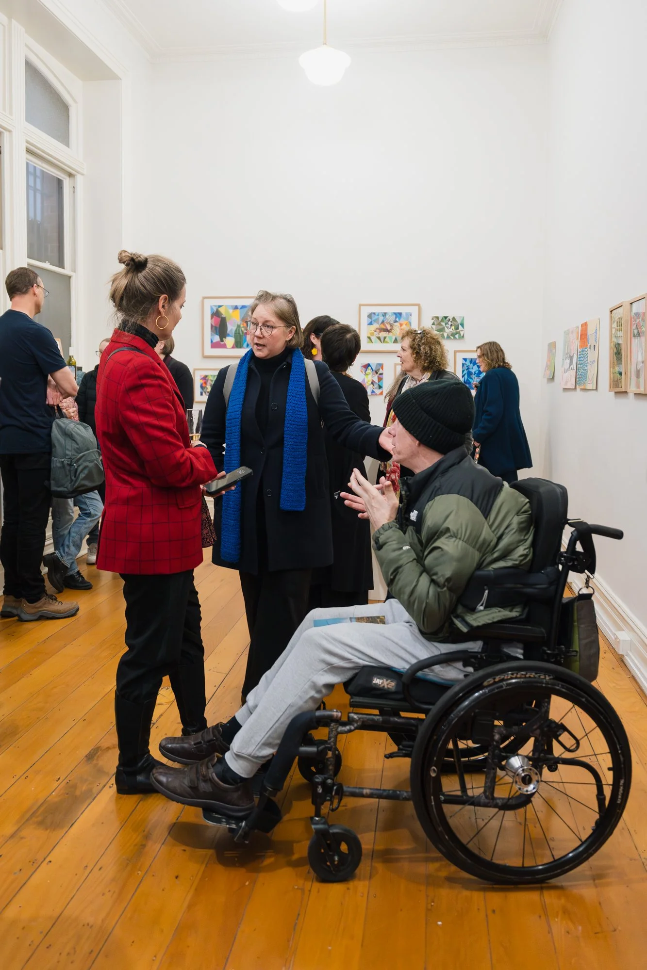 Opening of Convergence 2025 with people in a light filled gallery space.
