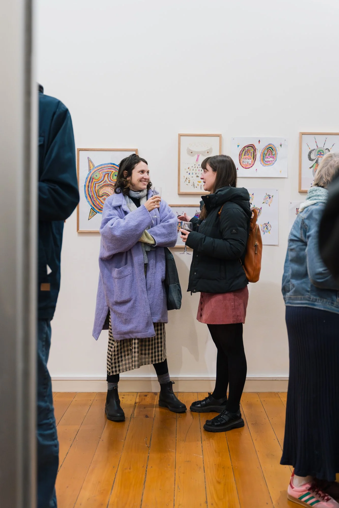 Opening of Convergence 2025 with people in a light filled gallery space.