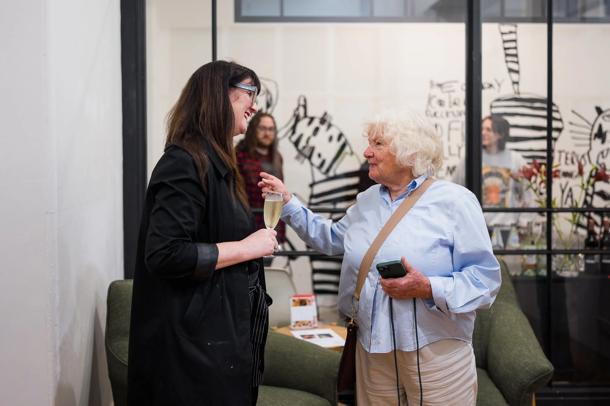Two people talking in a gallery space