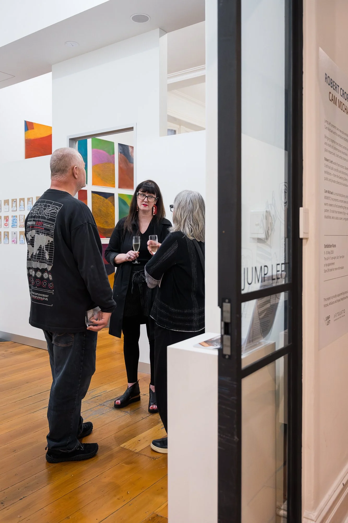 Two people talking at an exhibition