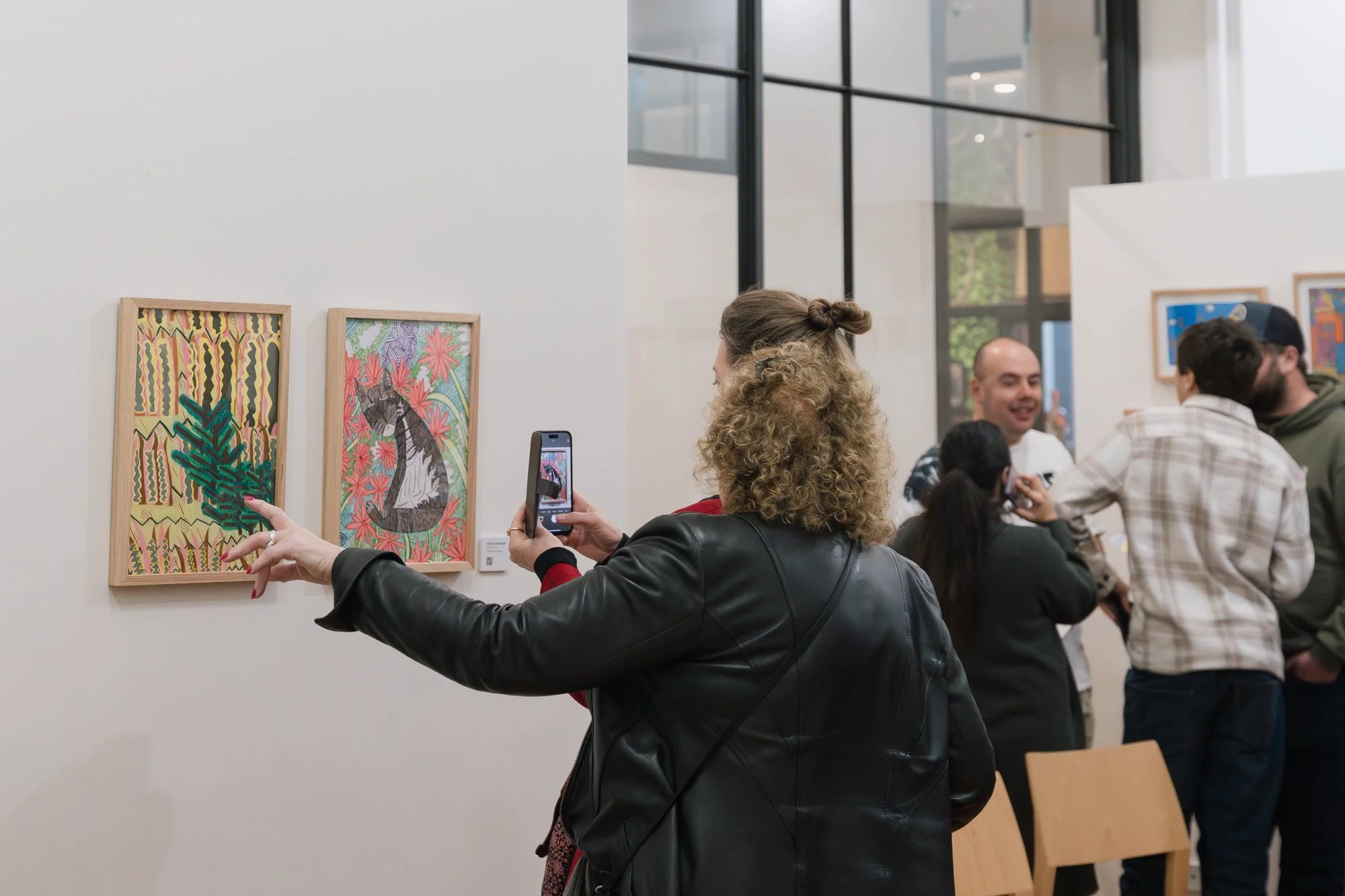 Opening of Convergence 2025 with people in a light filled gallery space.