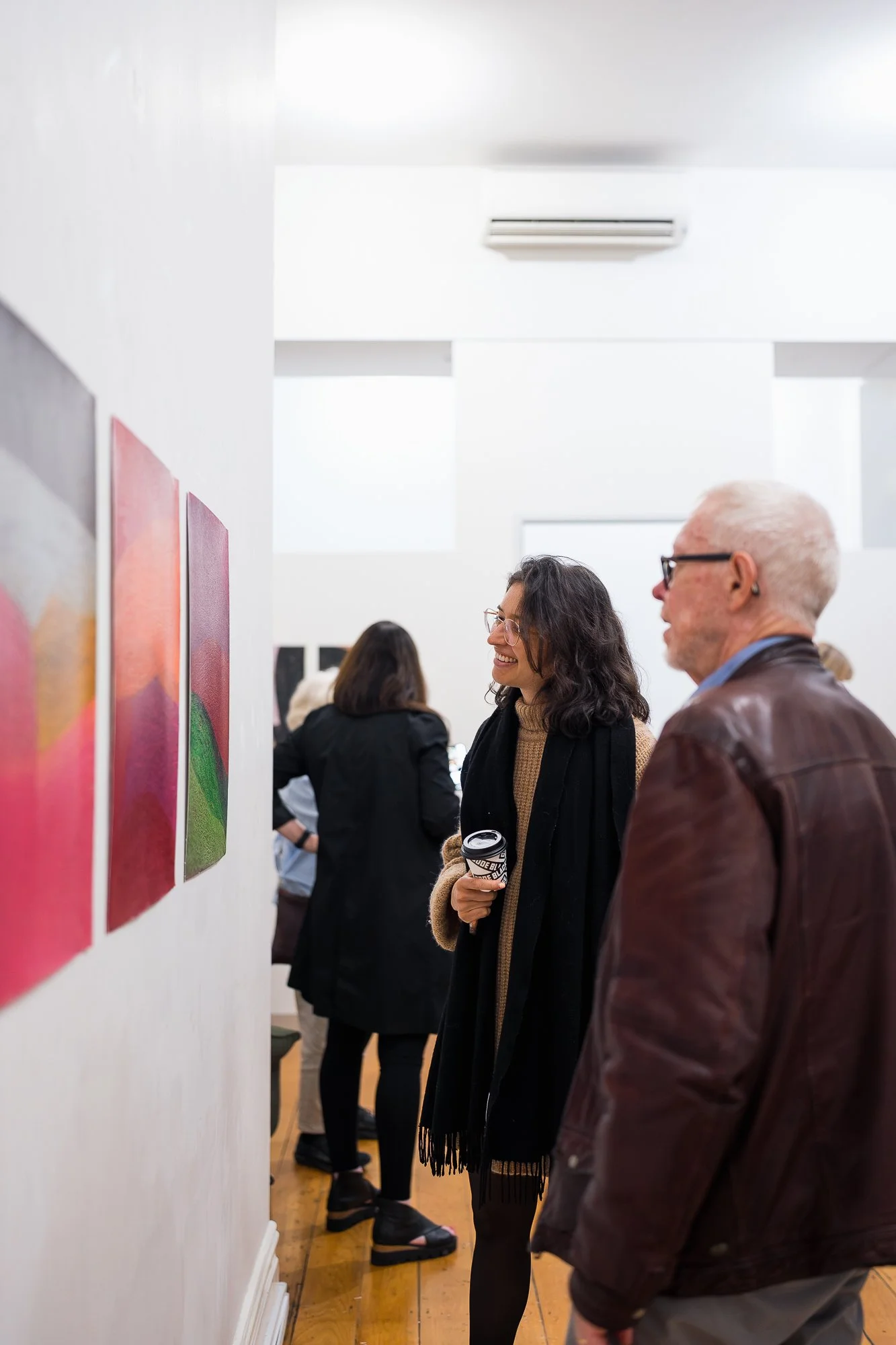 People observing an abstract drawing installation in an exhibition