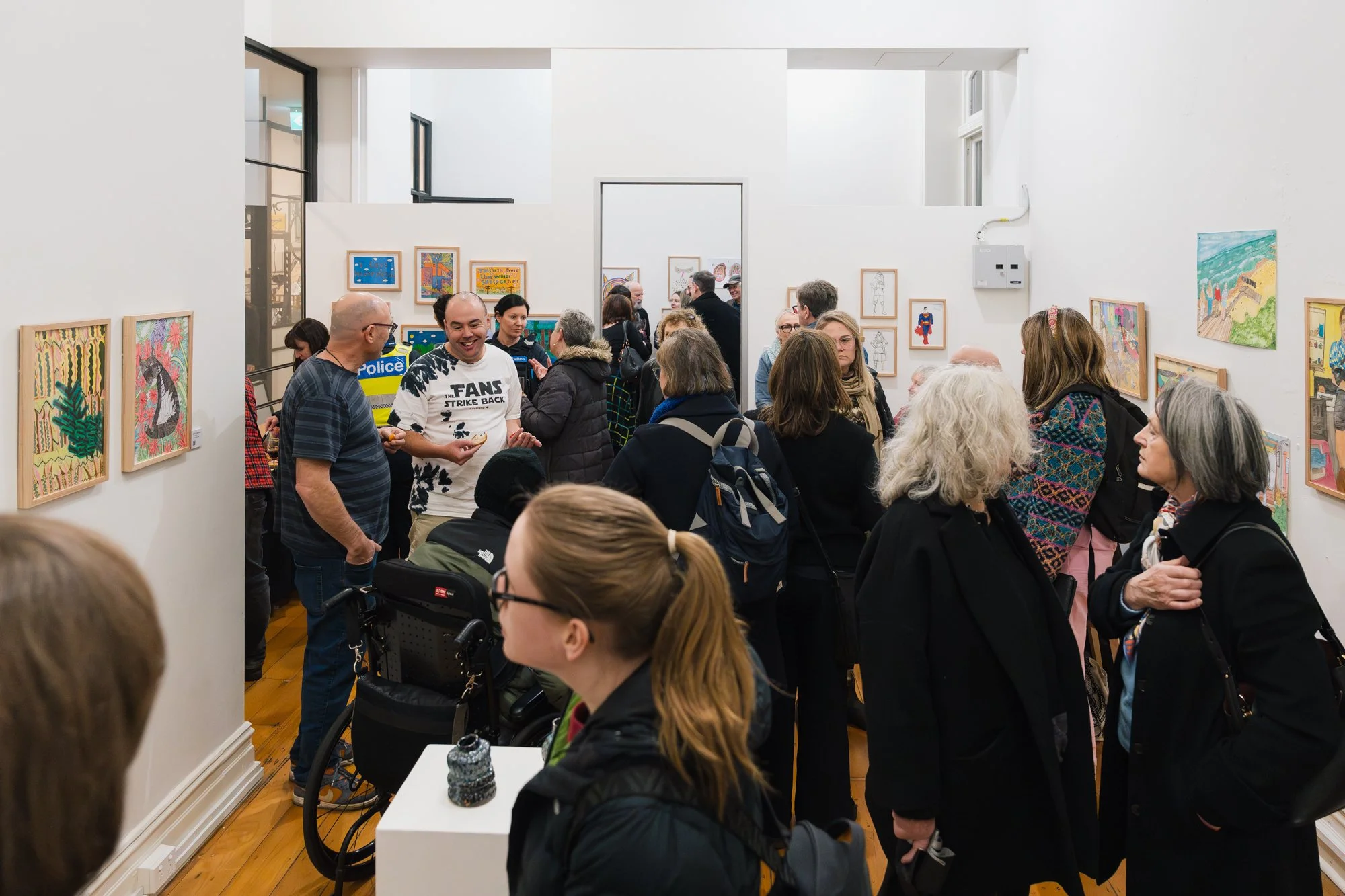Opening of Convergence 2025 with people in a light filled gallery space.