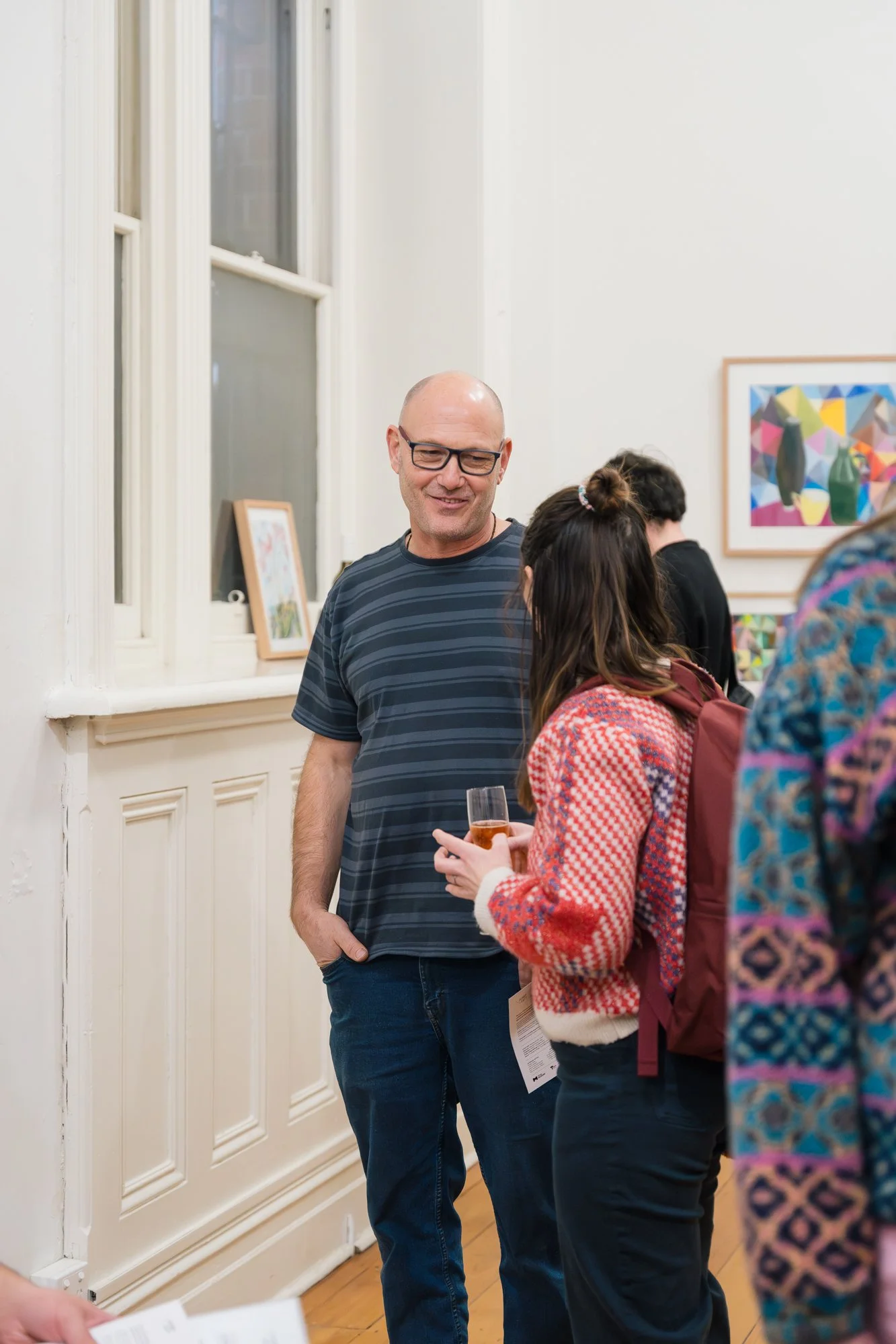 Opening of Convergence 2025 with people in a light filled gallery space.