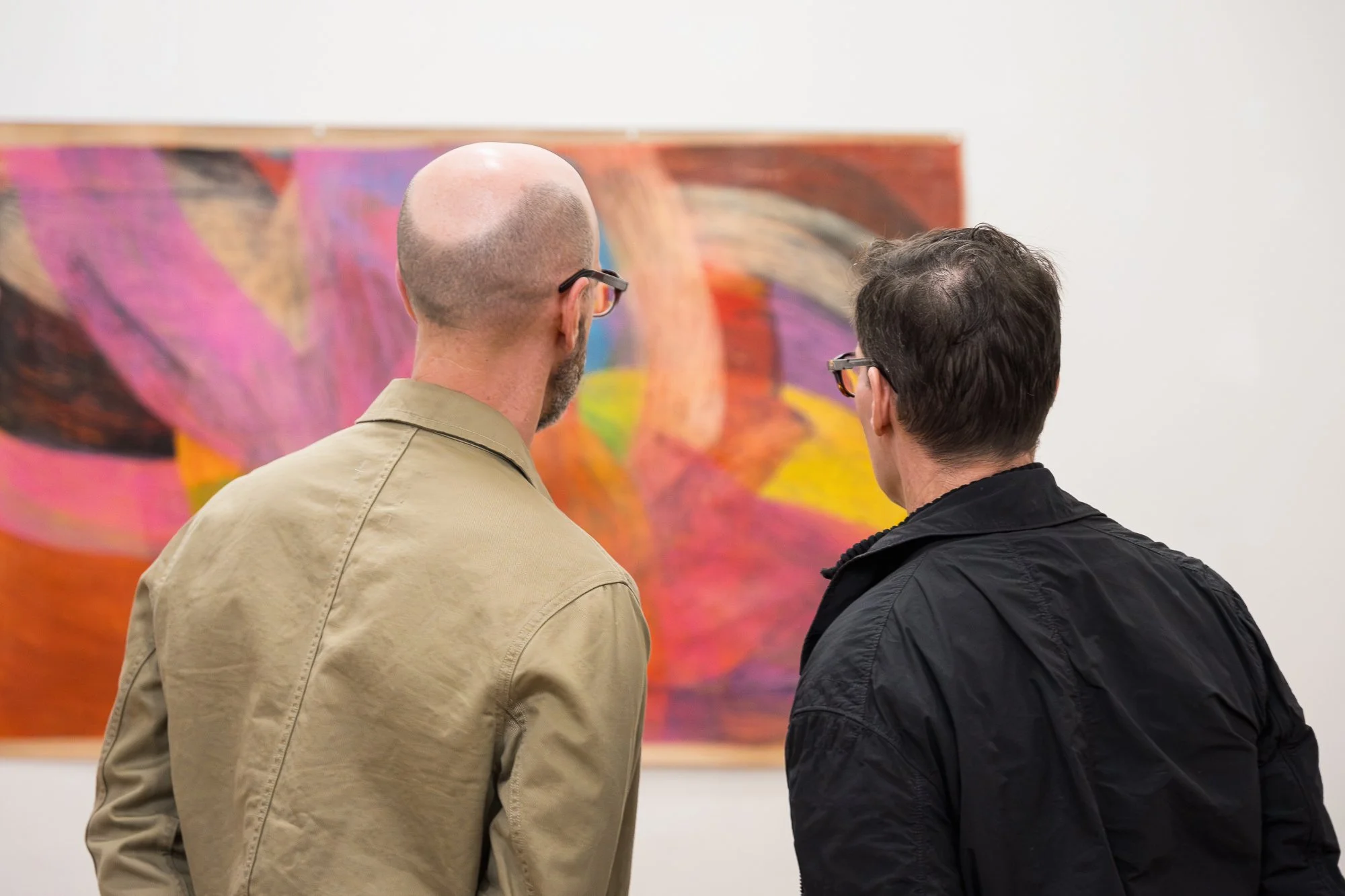 People observing an abstract drawing at an exhibition