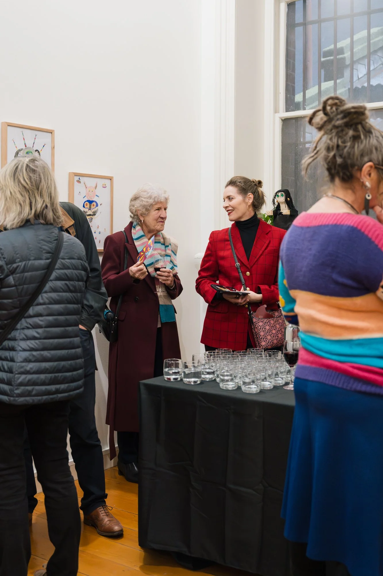 Opening of Convergence 2025 with people in a light filled gallery space.