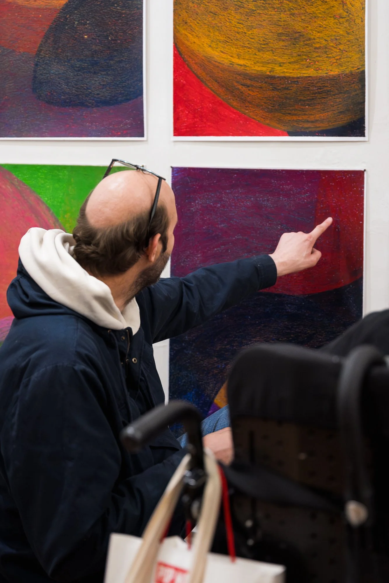 Person observing a large abstract drawing installation in an exhibition