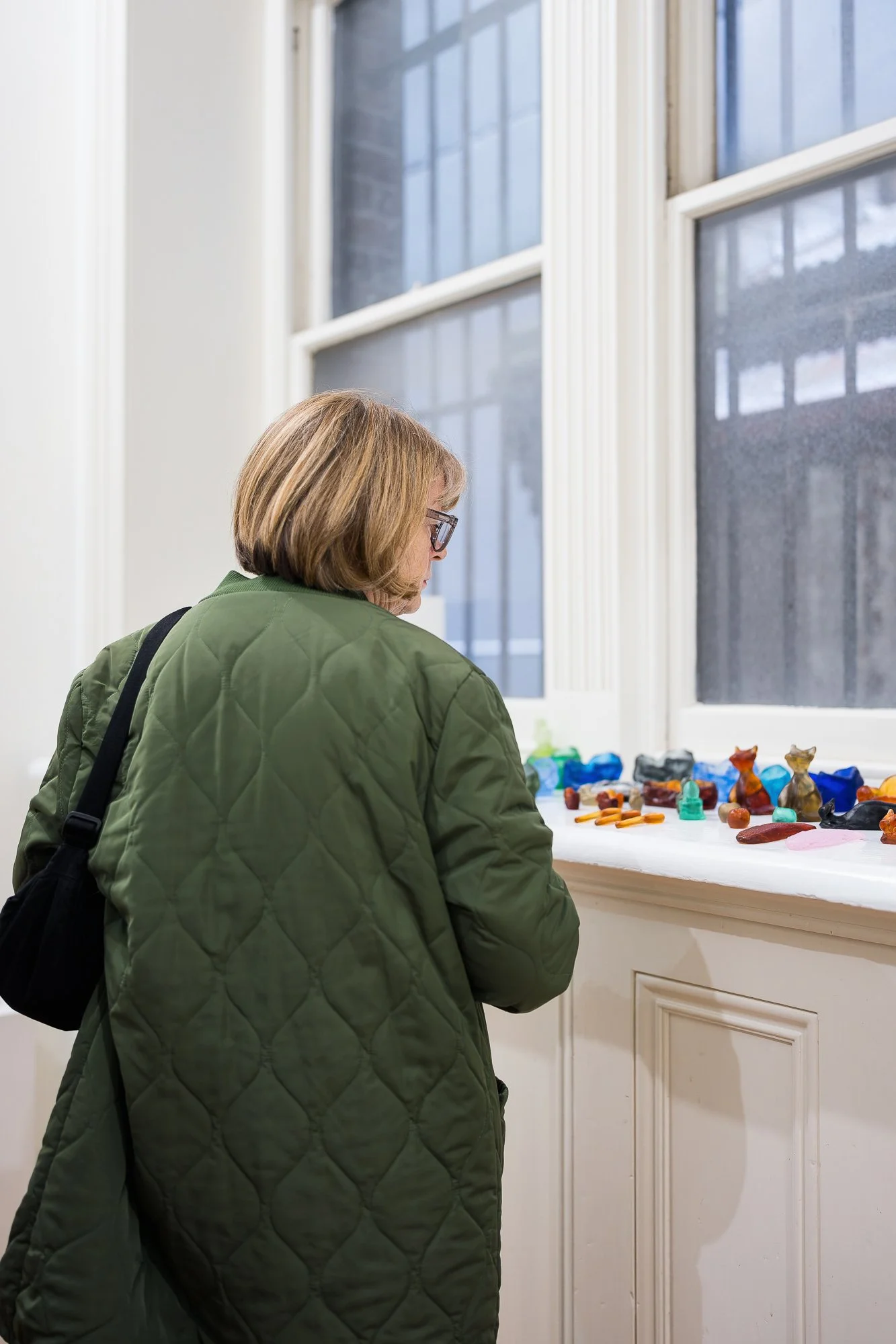Guest observing glass artworks in an exhibition