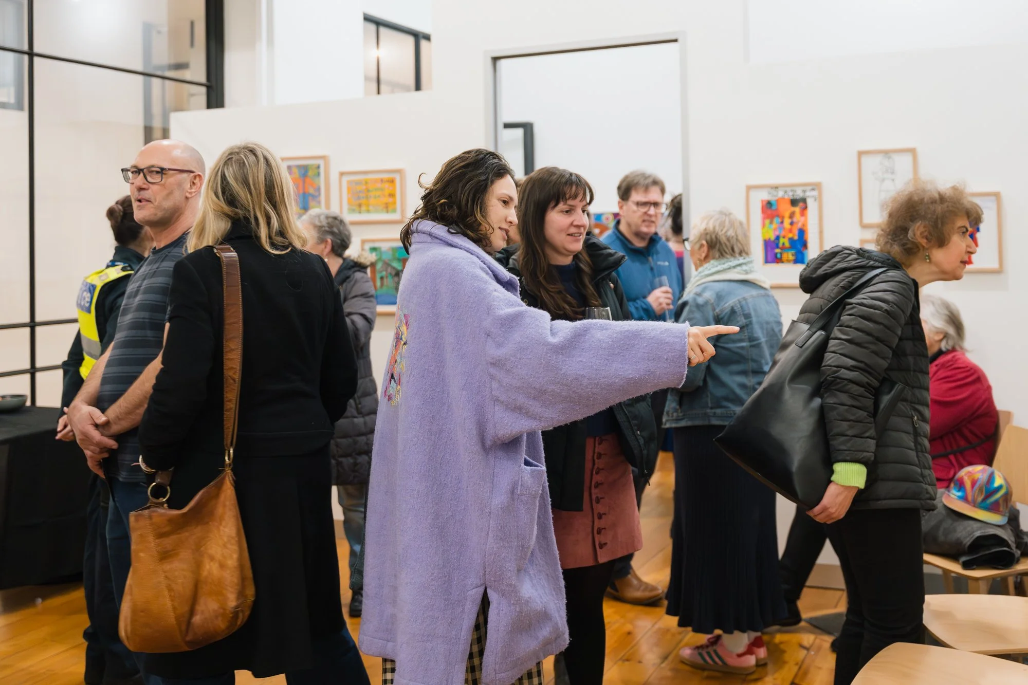 Opening of Convergence 2025 with people in a light filled gallery space.