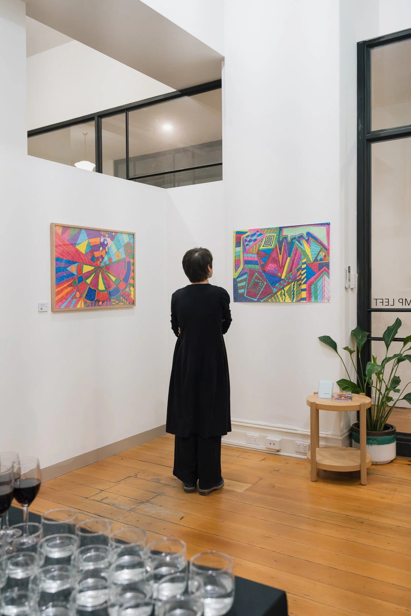 Opening of Convergence 2025 with a person in a light filled gallery space.