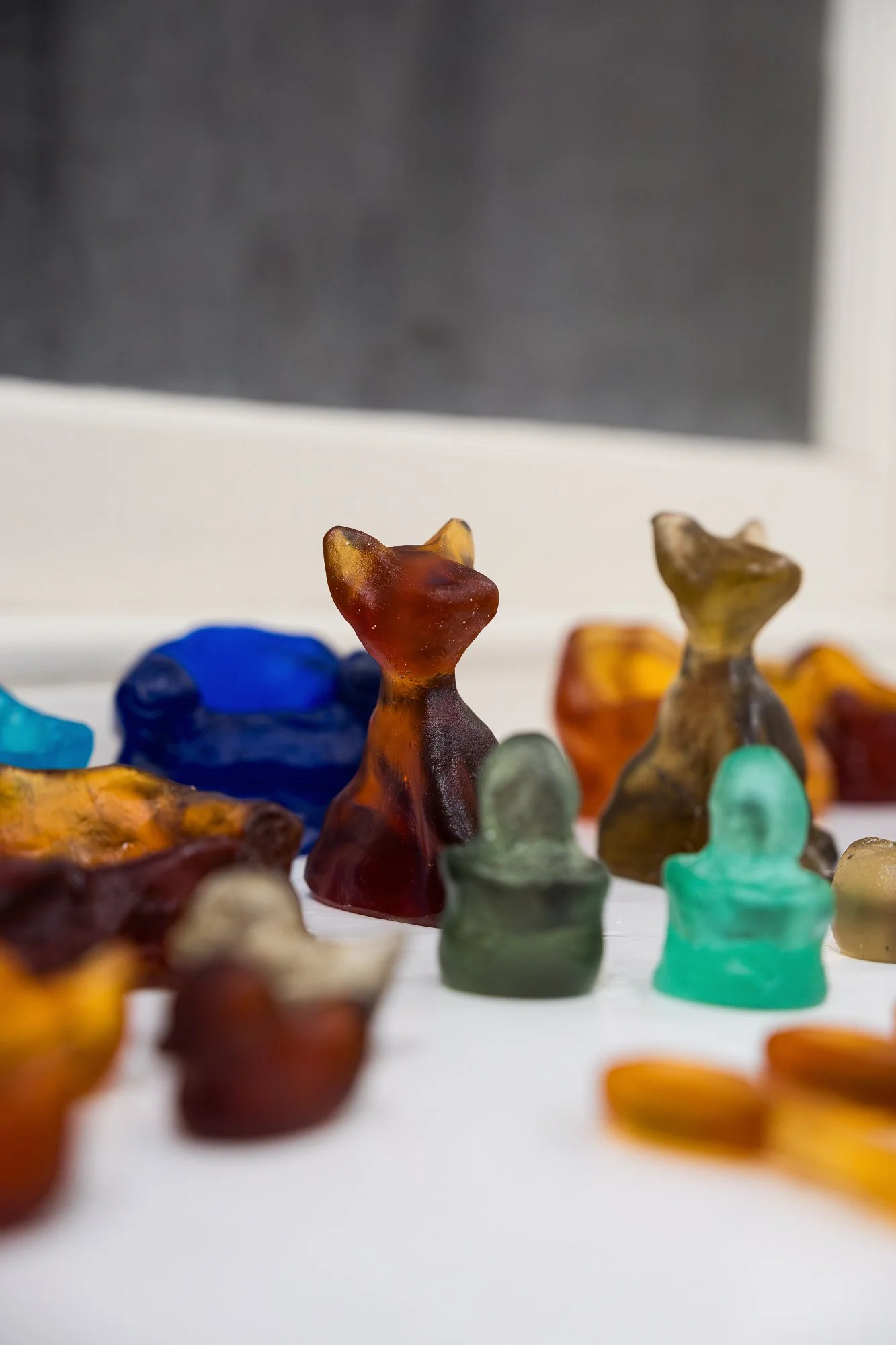Close-up of colourful glass artworks on display in an exhibition