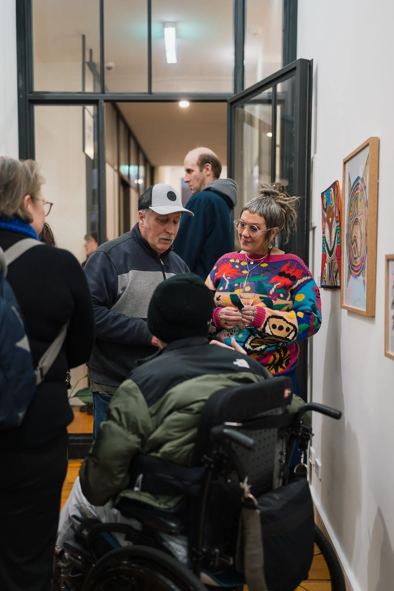 Opening of Convergence 2025 with people in a light filled gallery space.