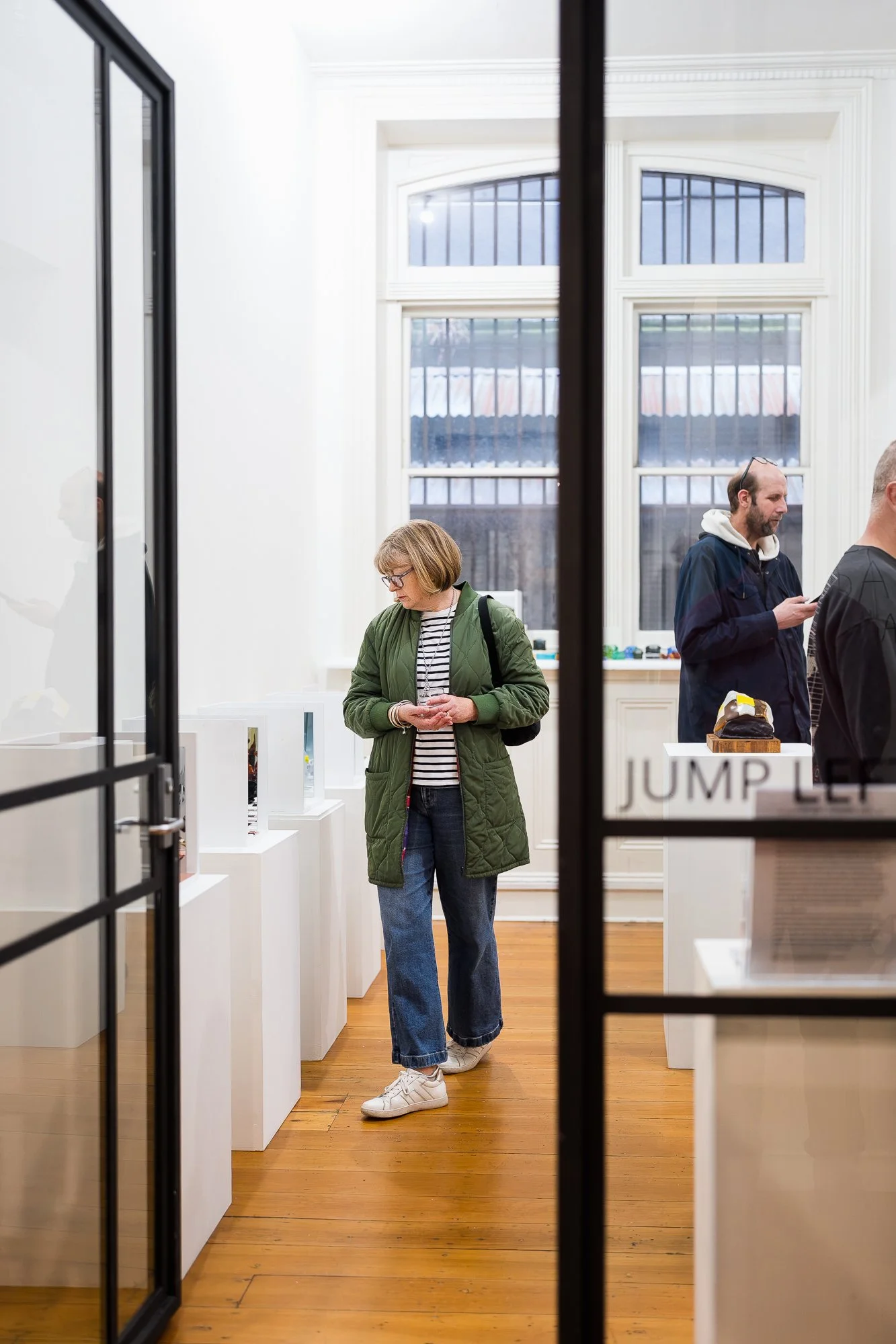 Guest observing glass artworks in an exhibition