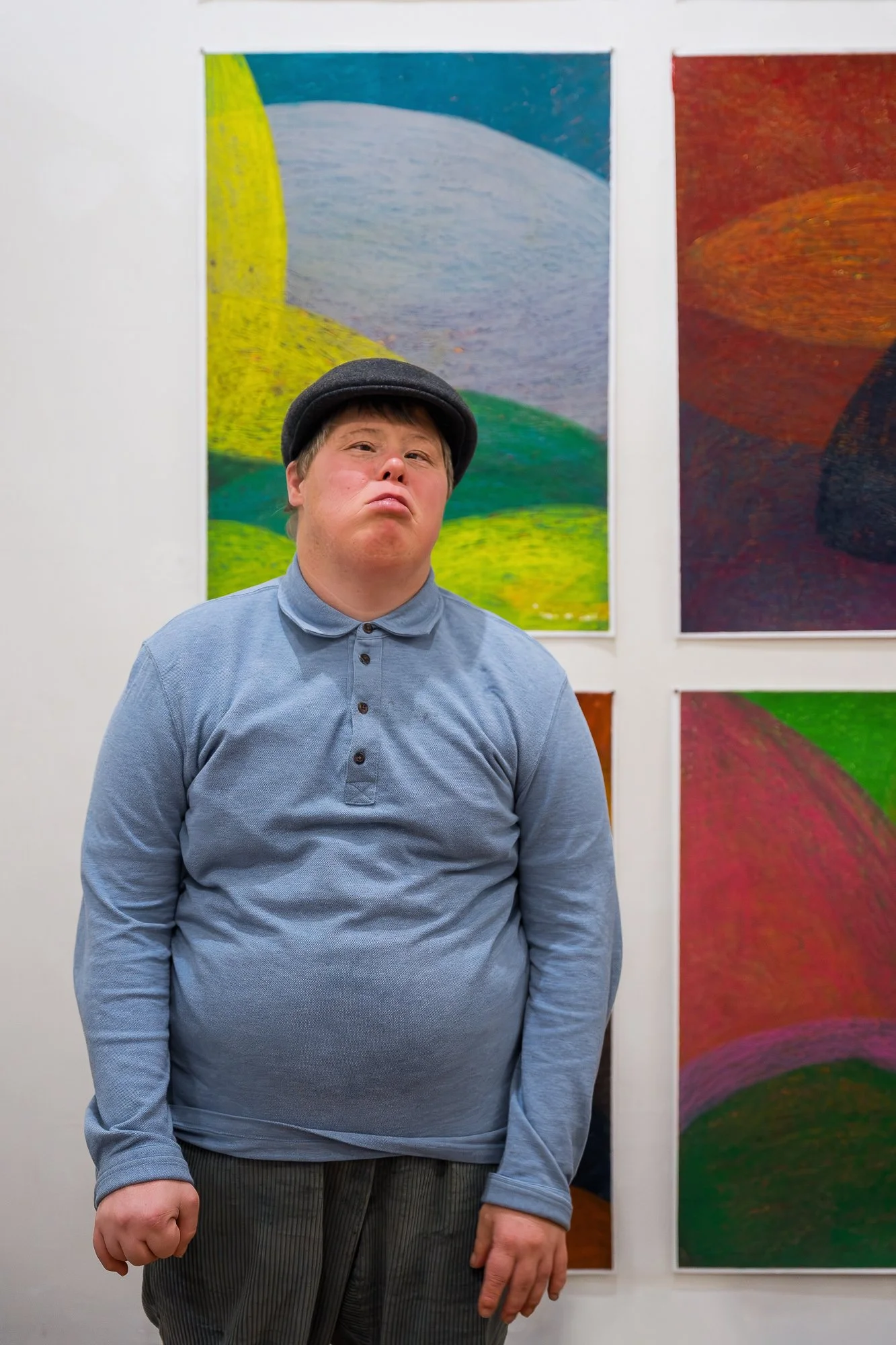 Artist in front of an installation of their artwork