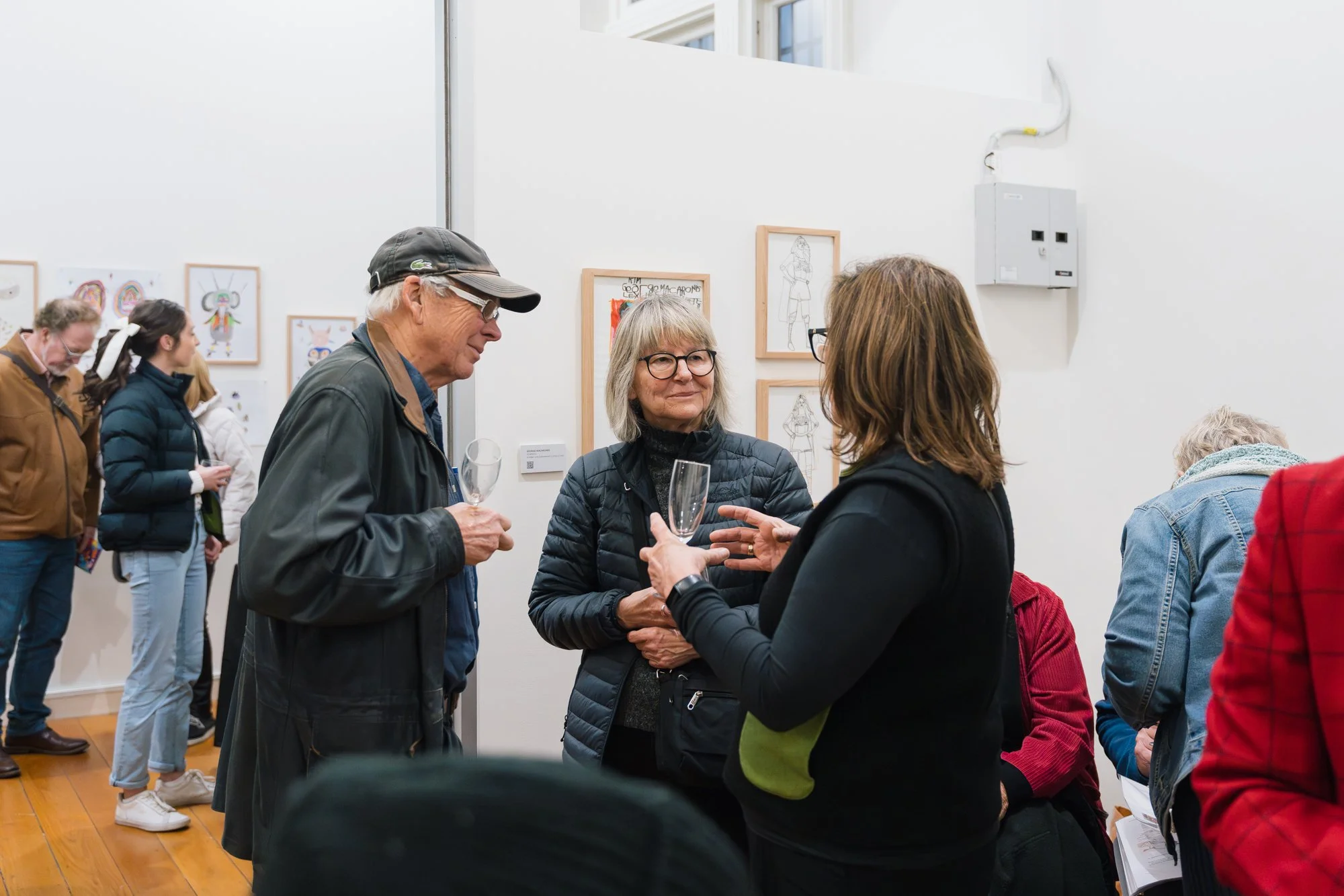 Opening of Convergence 2025 with people in a light filled gallery space.