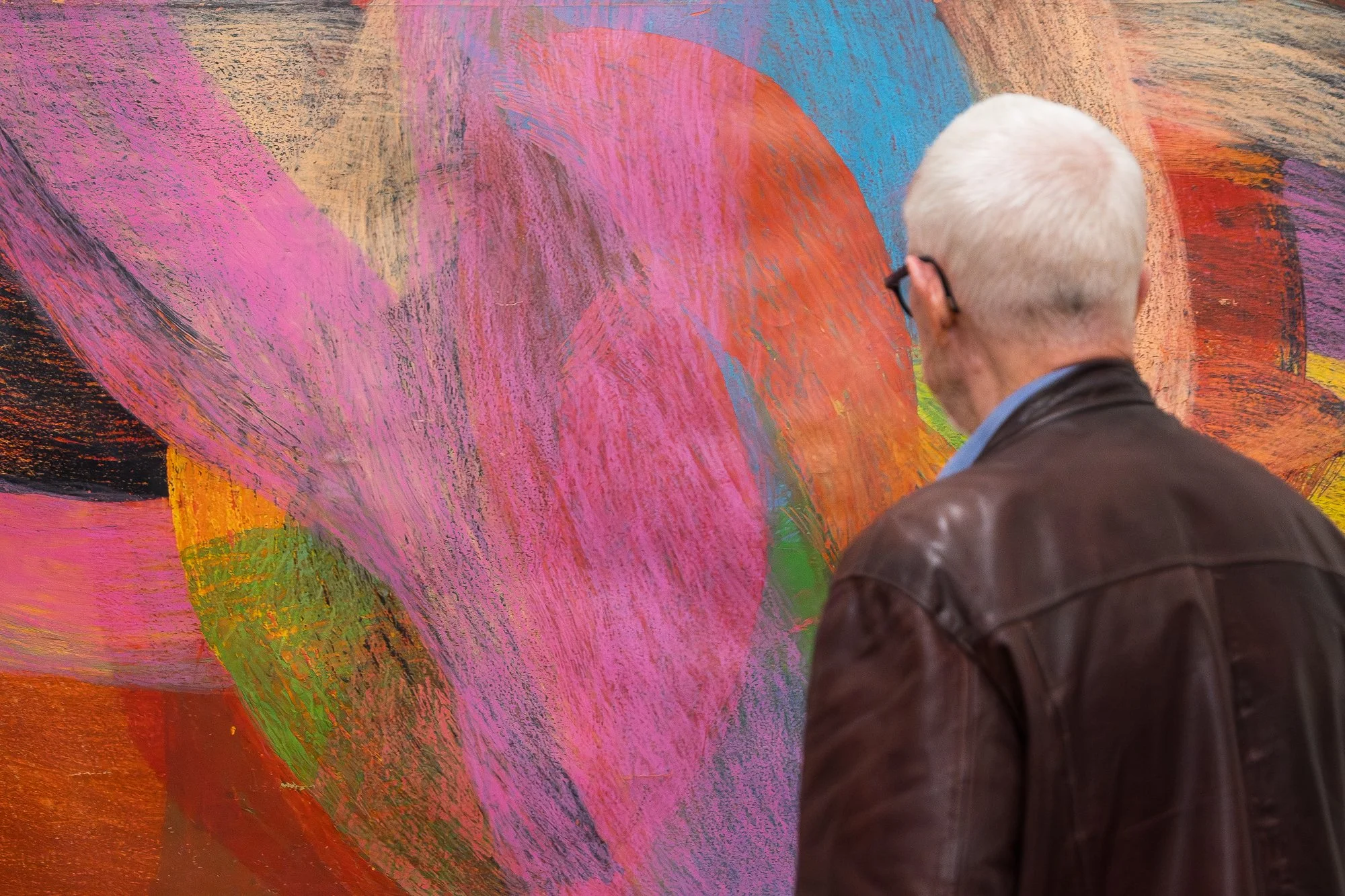 Guest observing a large abstract drawing in an exhibition