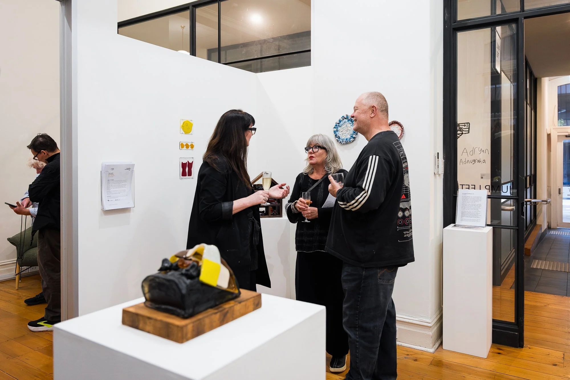 Guests talking happily at an exhibition opening
