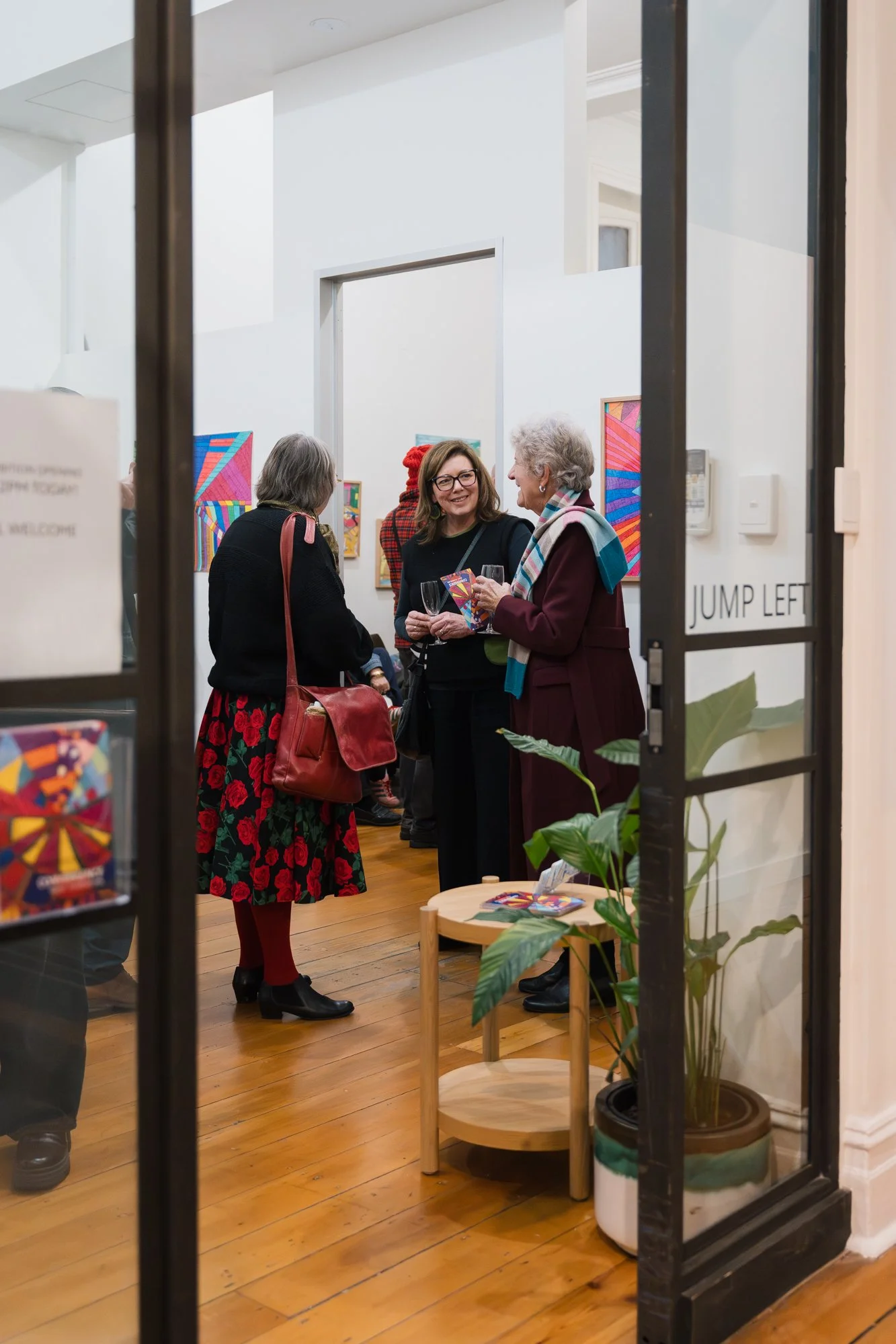 Opening of Convergence 2025 with people in a light filled gallery space.