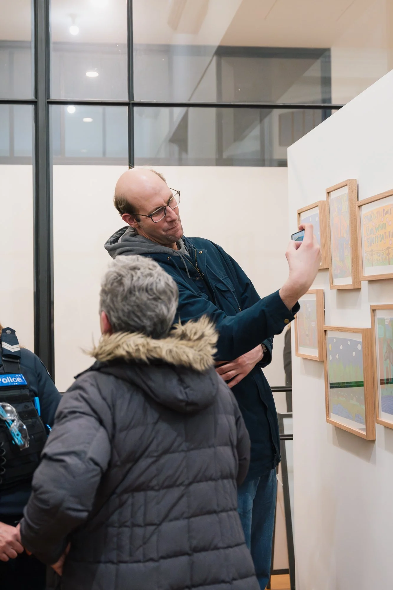 Opening of Convergence 2025 with people in a light filled gallery space.