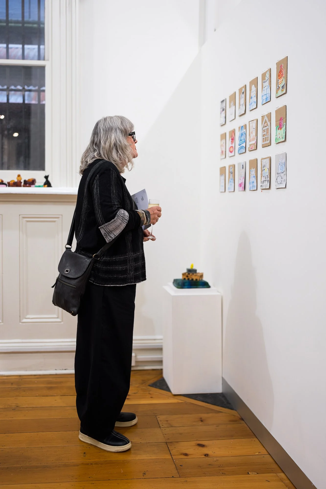 Guest observing artworks in an exhibition