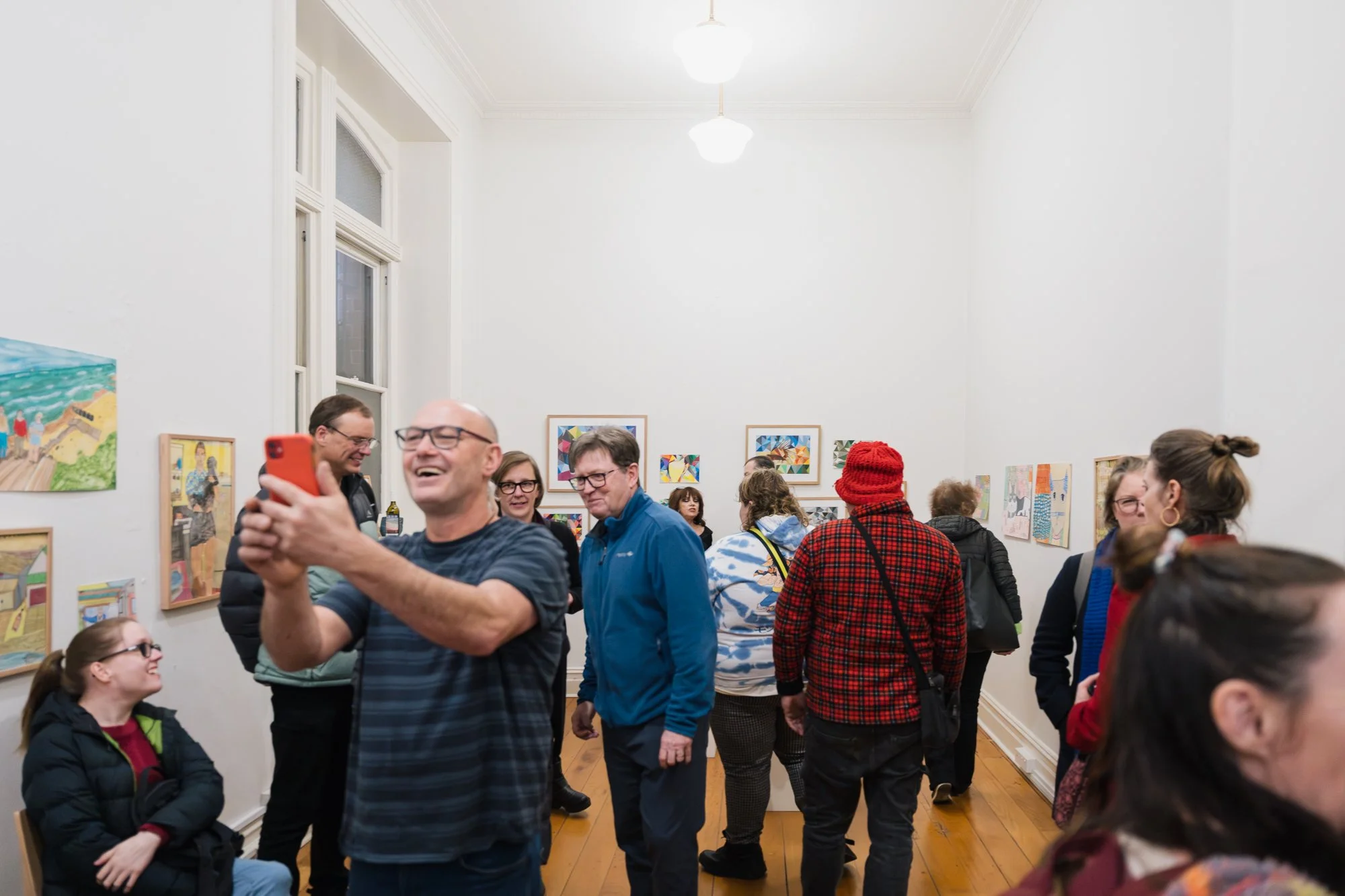 Opening of Convergence 2025 with people in a light filled gallery space.