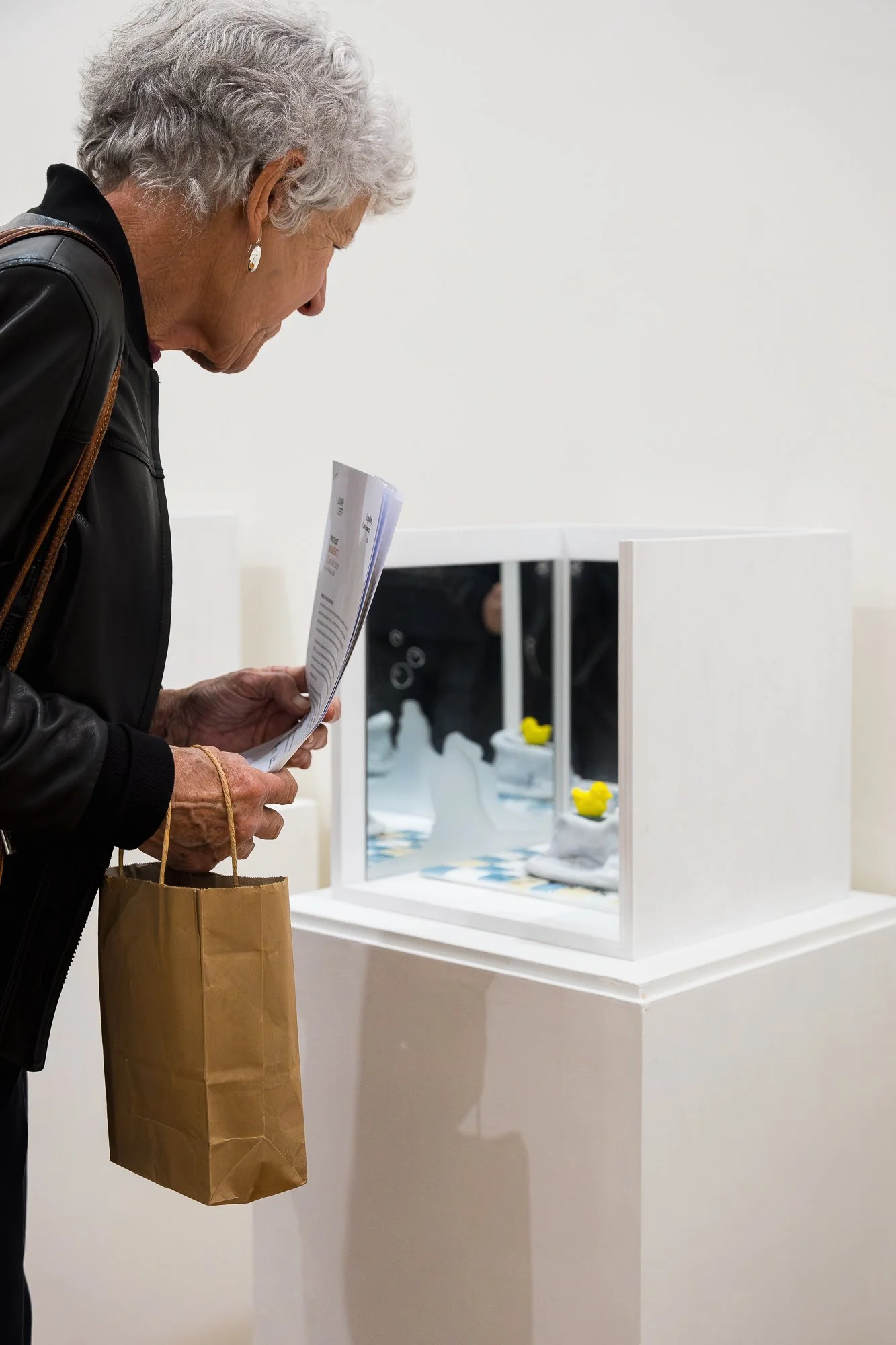 Guest observing glass artworks in an exhibition