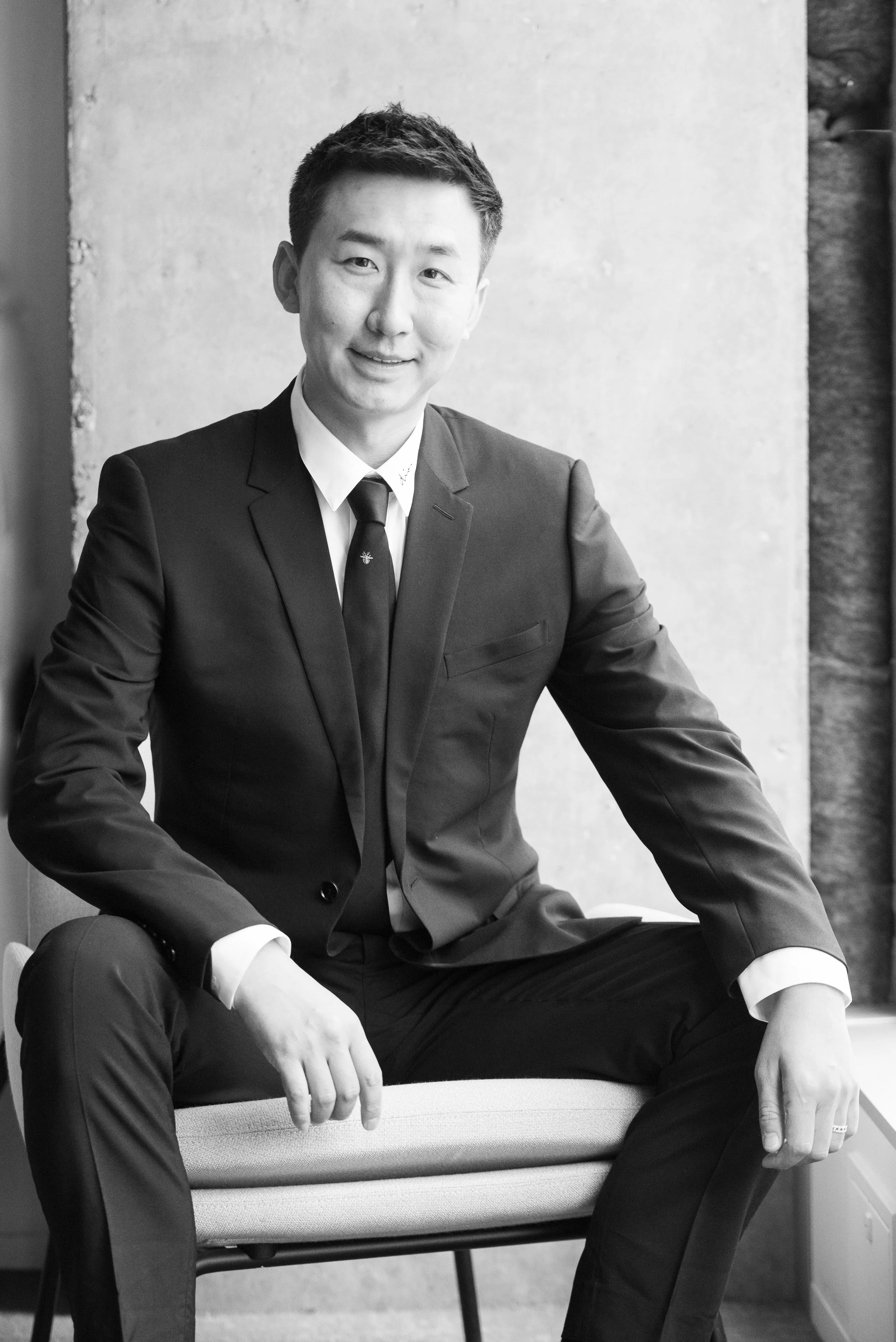 male realestate manager sitting looking at camera black and white image
