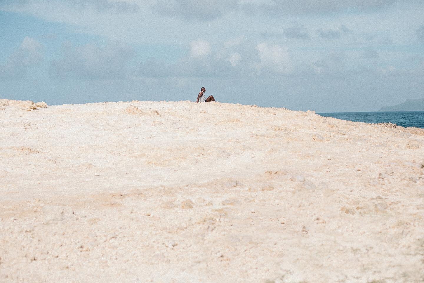 We went to the easternmost tip of Grande-Terre island, Guadeloupe and was met by this view. A man sitting alone at the top of a cliff looking towards the sea. It was such a beautiful moment, I thought, he was just sitting there so quiet, lost in his 