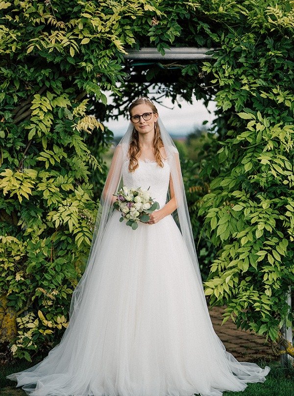 Alles ist bereit.
Das Kleid sitzt, der Strau&szlig; in den H&auml;nden und trotzdem f&uuml;hlt es sich nicht gestellt an.

Eher wie ein stilles Ankommen.

Zwischen all dem Trubel
ein kurzer Blick nach innen.

Ein tiefes Durchatmen. Ein kleines L&auml