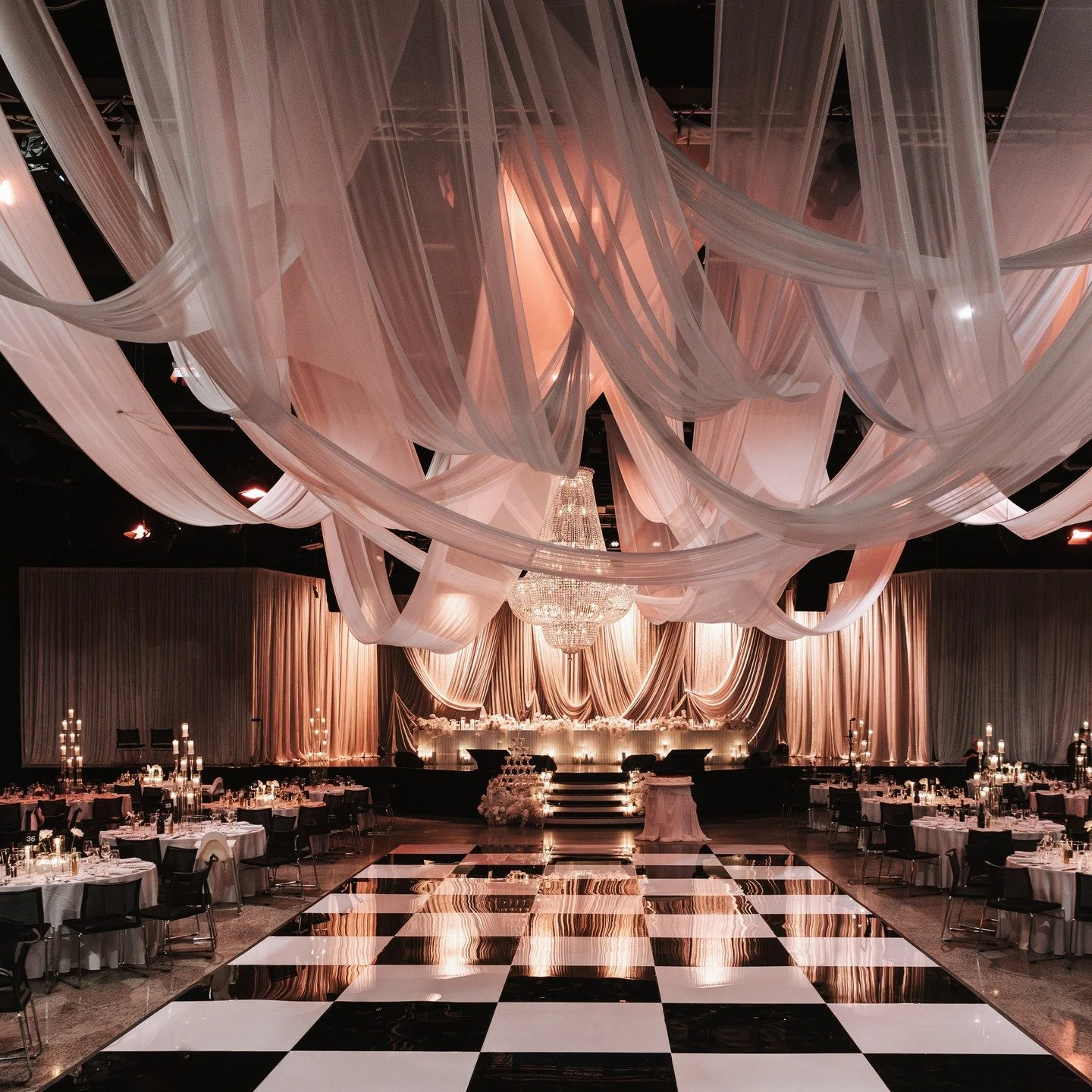 Can we take a moment for these ceiling drapes? Floating elegance, layered textures, and the perfect lighting. 
Ceiling draping, dance floor, bridal table, bridal table styling, centrepieces, cake table, staircase florals, champagne tower, guest list