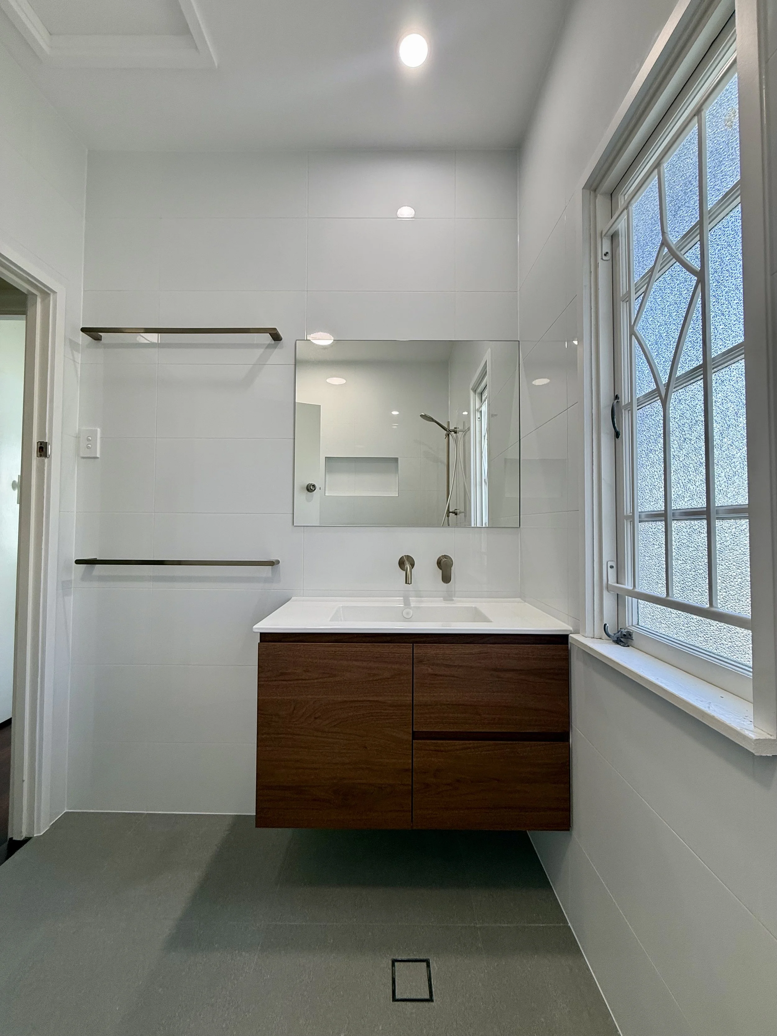 Completed Mount Gravatt East bathroom with retained decorative window