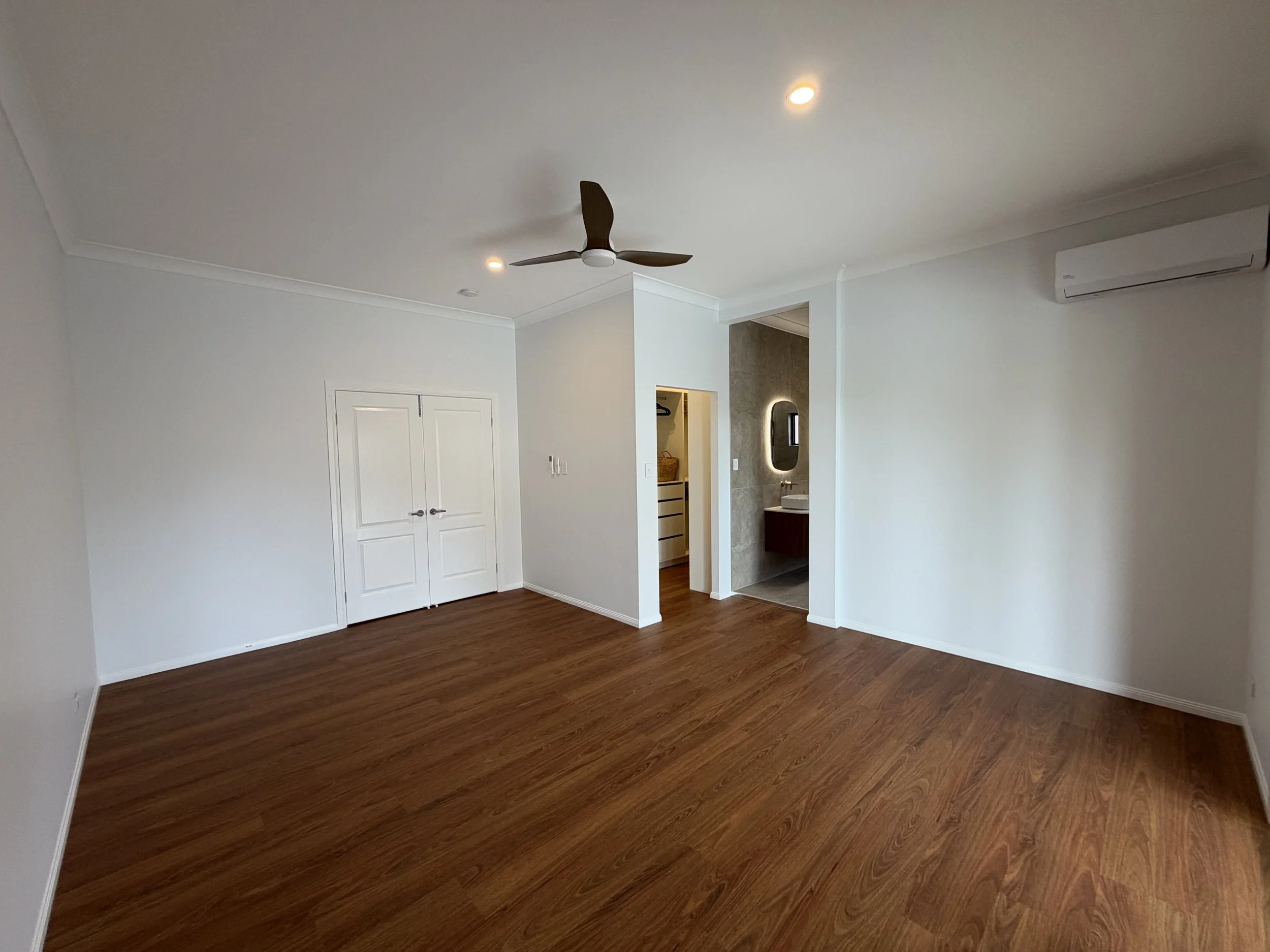Bedroom renovation in Wellington Point featuring new Queensland Spotted Gum luxury vinyl plank flooring and ceiling fan.