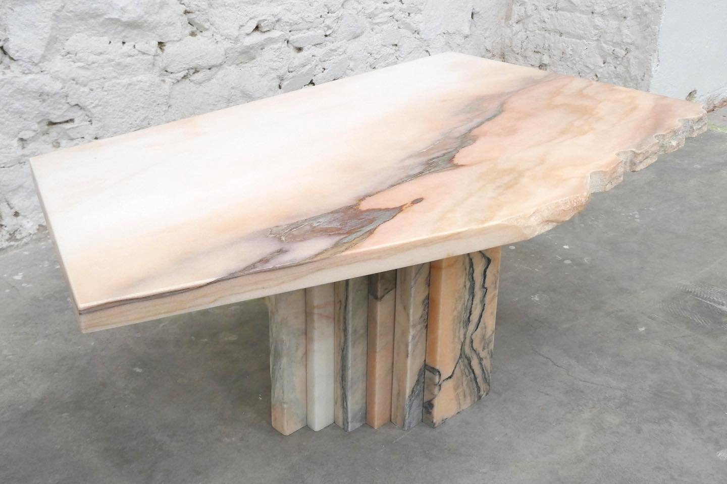 Our Freeform ONDA coffee table in reclaimed Rosa Aurora. 
A rough edge remains as salvaged, referencing the origins of this natural stone and providing evidence of the process of blasting extraction. 
From deep blues to soft reds, the tiered design o
