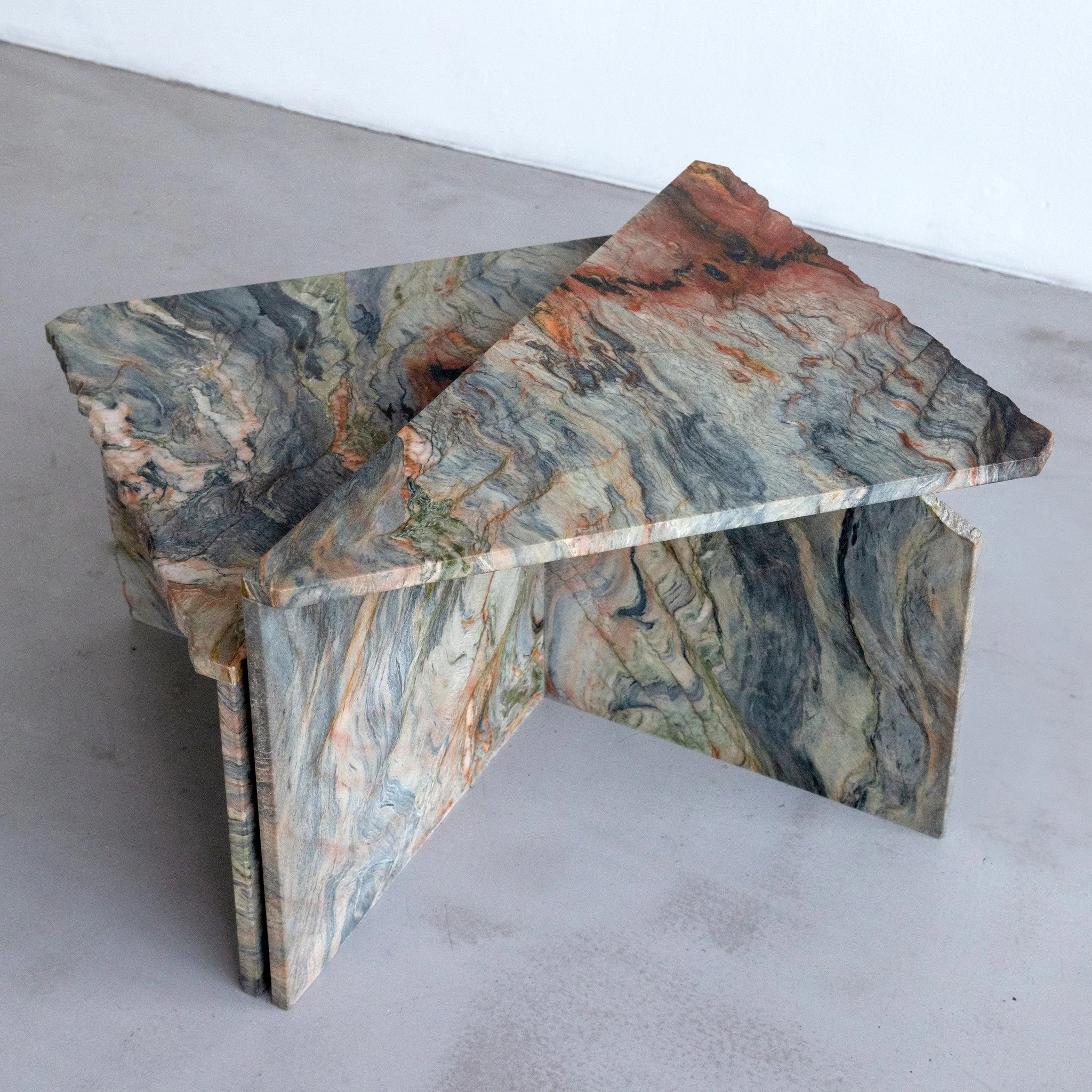 The Rift Table takes its final shape through the material, allowing its inherent character to lead the design.

Each element retains the memory of its origin &mdash; freeform edges, natural breaks, and flowing veining &mdash; assembled into a balance