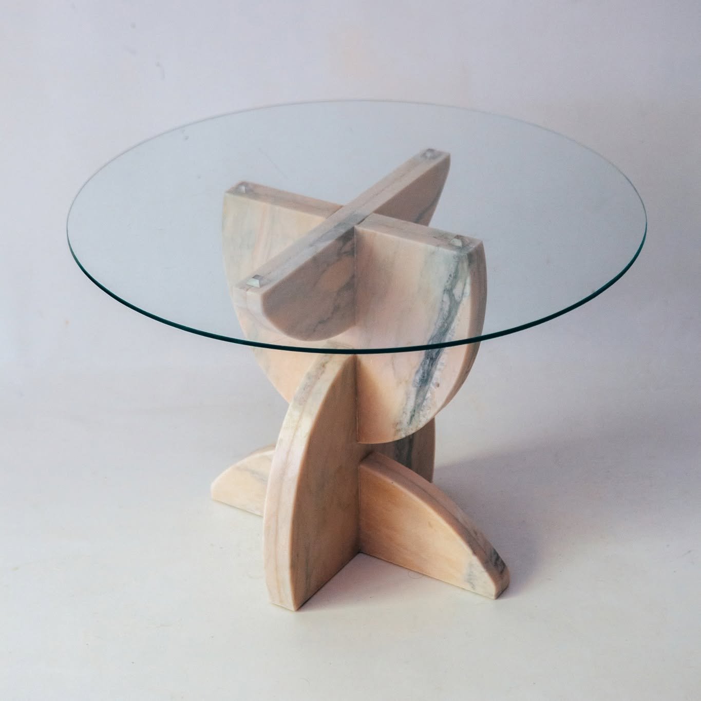 This sculptural table base design emerges from a composition of interlocking oval forms.
These shapes originate from oval sink cut-outs, stacked in their hundreds and left unused for decades.
Since being salvaged, these egg-shaped offcuts have found 