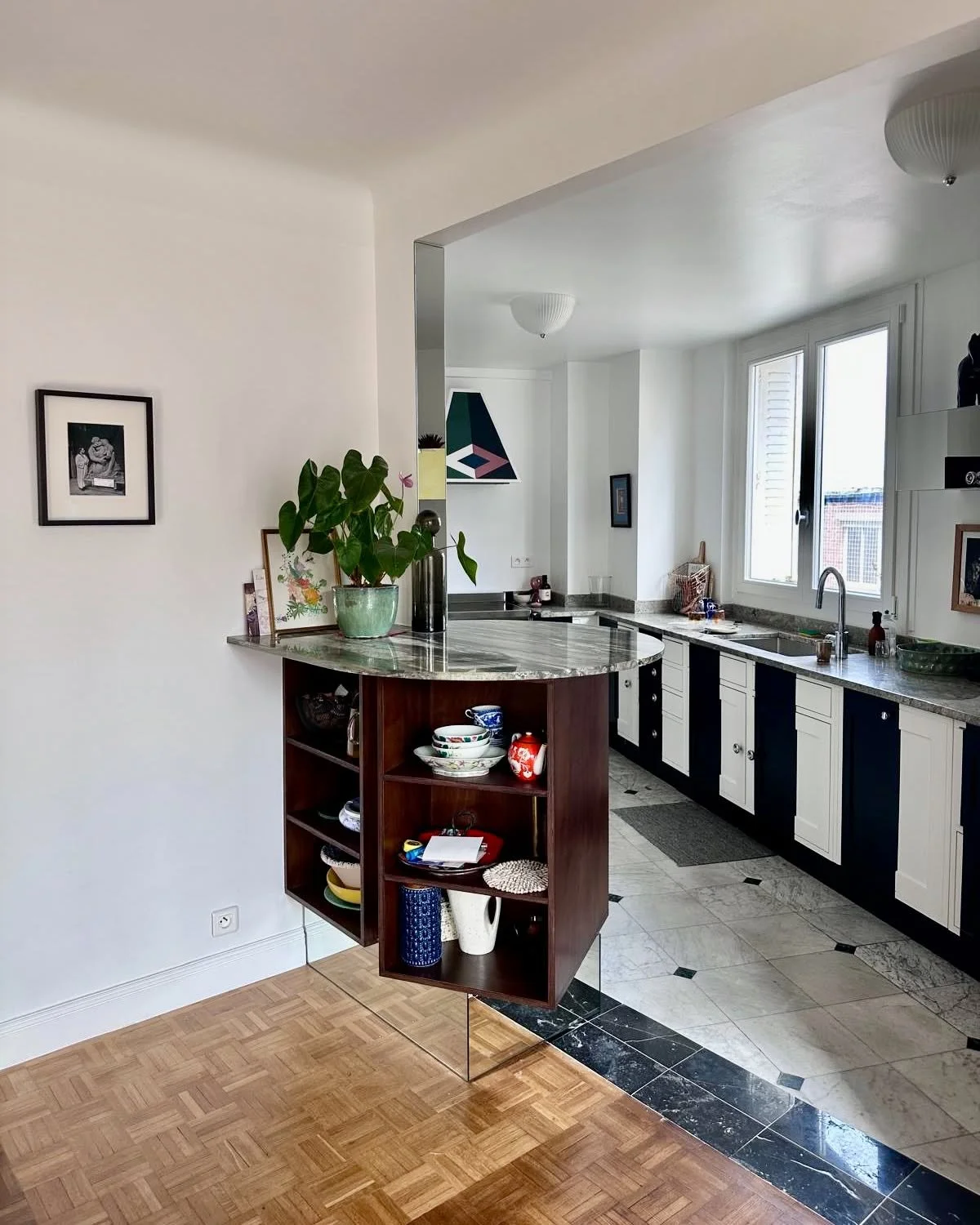 In the kitchen of this Montmartre apartment renovation, special attention was given to how materials connect and define the space.
For the island, a larger single slab was required, and we managed to salvage an off-cut from a stonemason in the same I