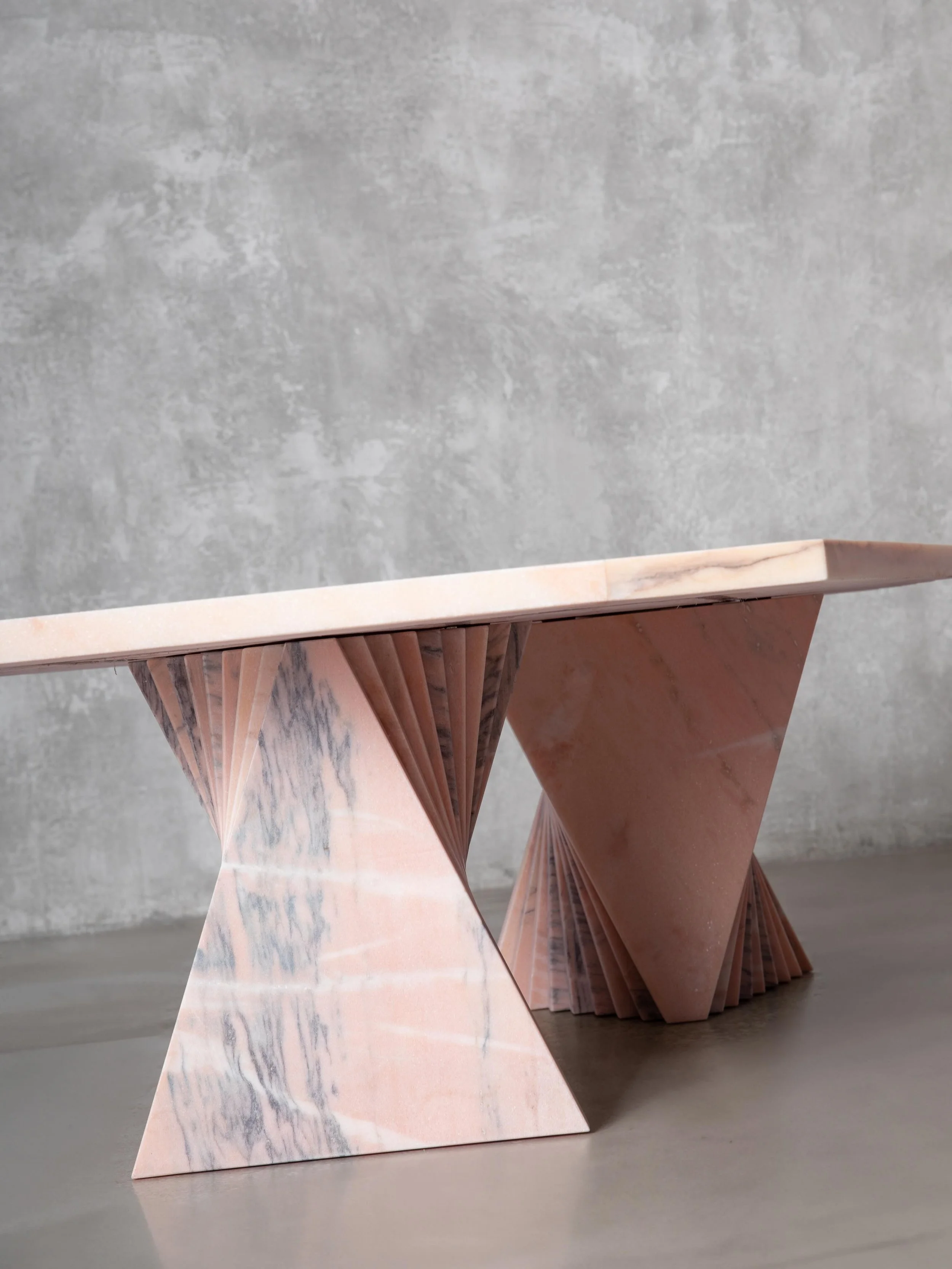 Kaleidoscope outdoor table &mdash; crafted from reclaimed Rosa Aurora marble offcuts once buried beneath decades of natures decay.

This Portuguese pink marble was a joy to rework into the twisting triangular forms that create a shifting sense of mov