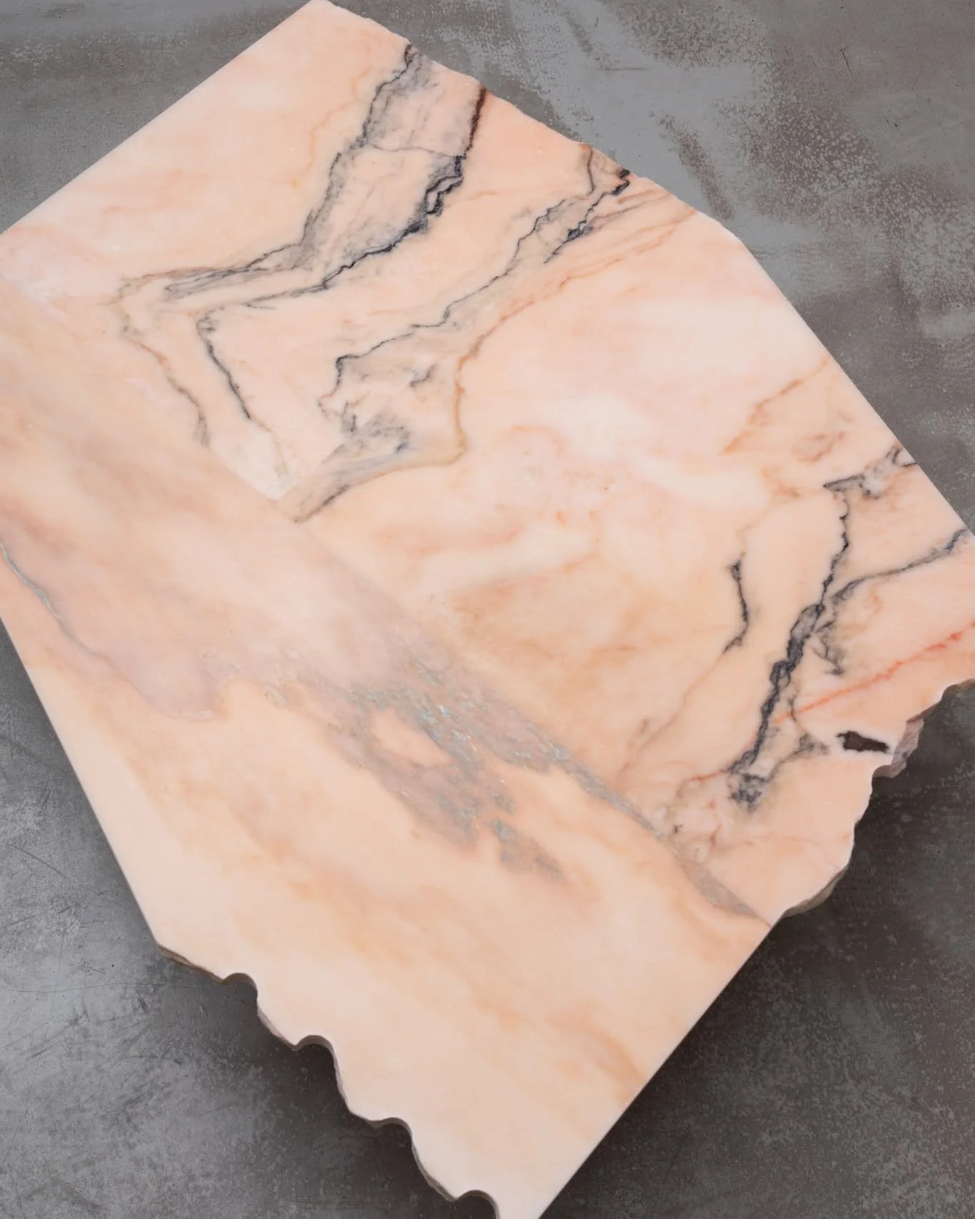 Commissioned as an expansive outdoor coffee table in reclaimed Rosa Portugal marble, the challenge lay in scale. No single offcut was large enough to achieve the dimensions required, so we carefully composed the top from three rescued fragments.

Thr