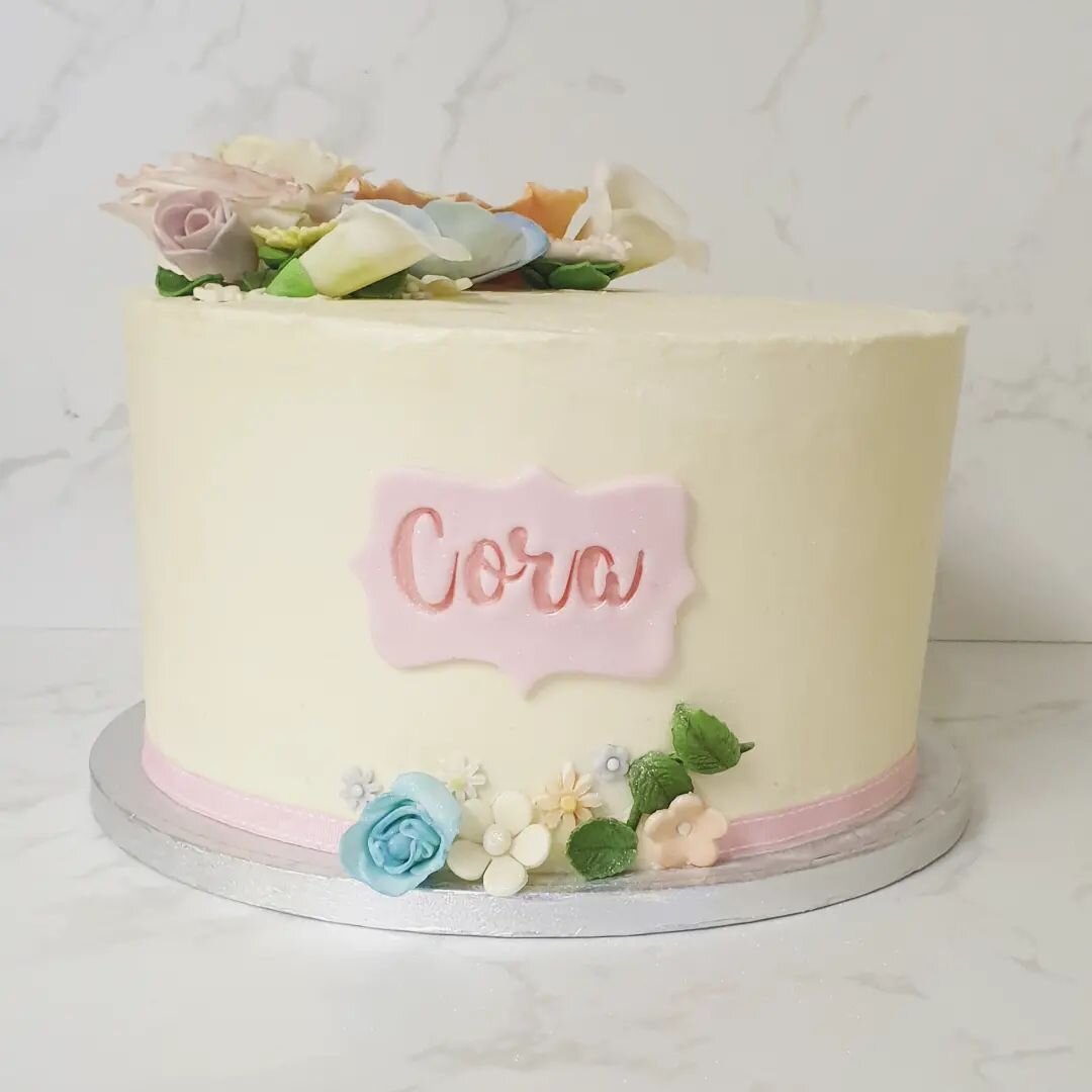 Sometimes less is more... 

My brief for this christening cake was &quot;simple with different coloured flowers&quot; and I love it. 

It's a 9&quot; lemon cake filled and covered with Italian meringue buttercream. I was able to have some creative co