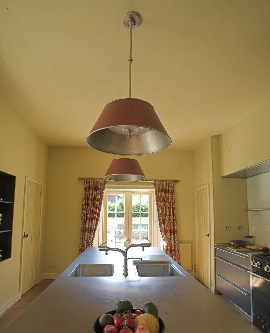Bespoke kitchen island pendant lighting.  These contemporary pendant lights can be colour matched to any paint colour.  Taking inspiration from the colours in the curtains, we have painted them in a colour from our friends just down the road in Wimbo