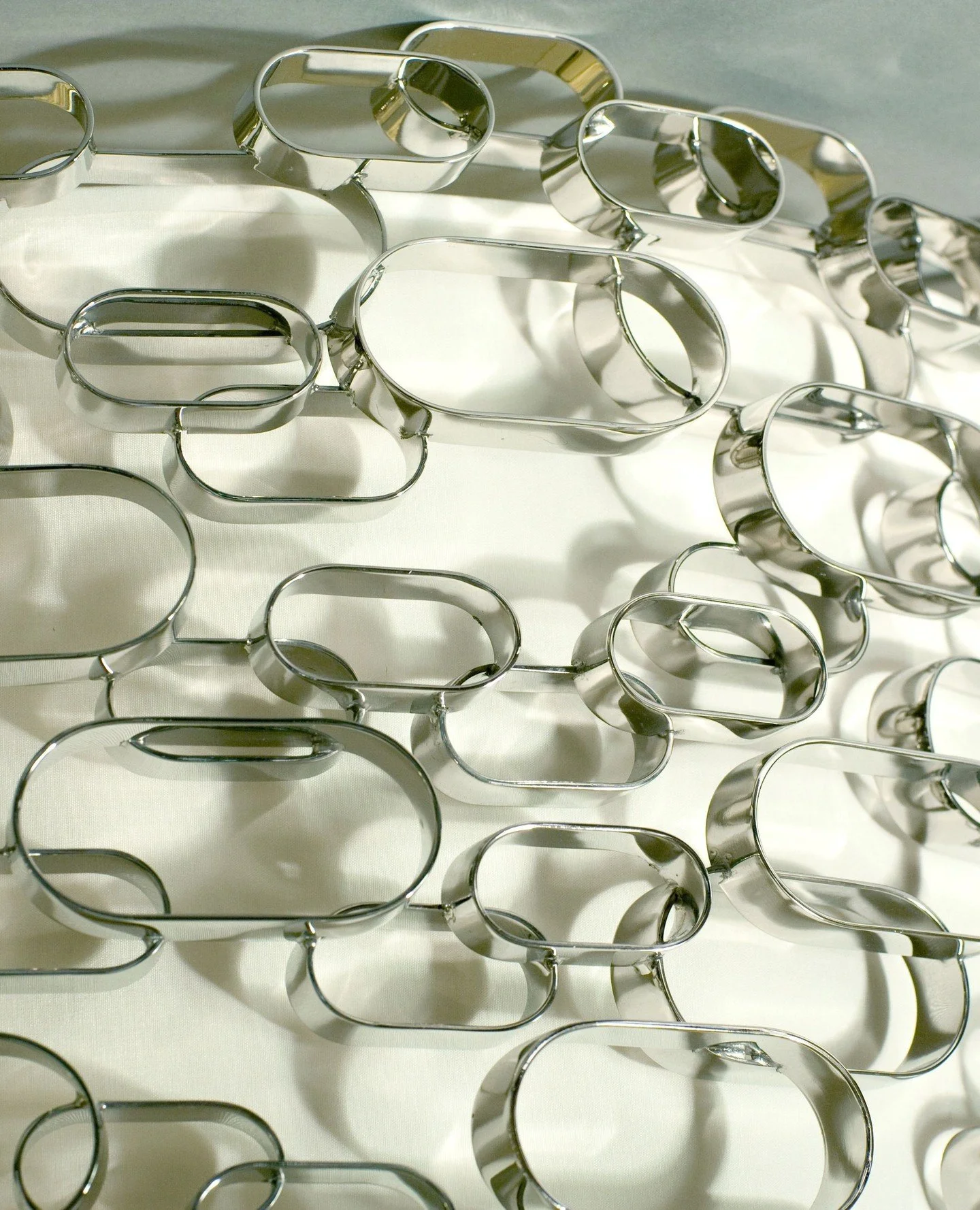 A detail of a beautifully polished nickel ceiling light.⁠
⁠
Made up of hundreds of 'obround" shapes, it presented us with a few challenges! "Obround refers to a pill-like shape, often described as a rectangle with rounded ends. It's a shape