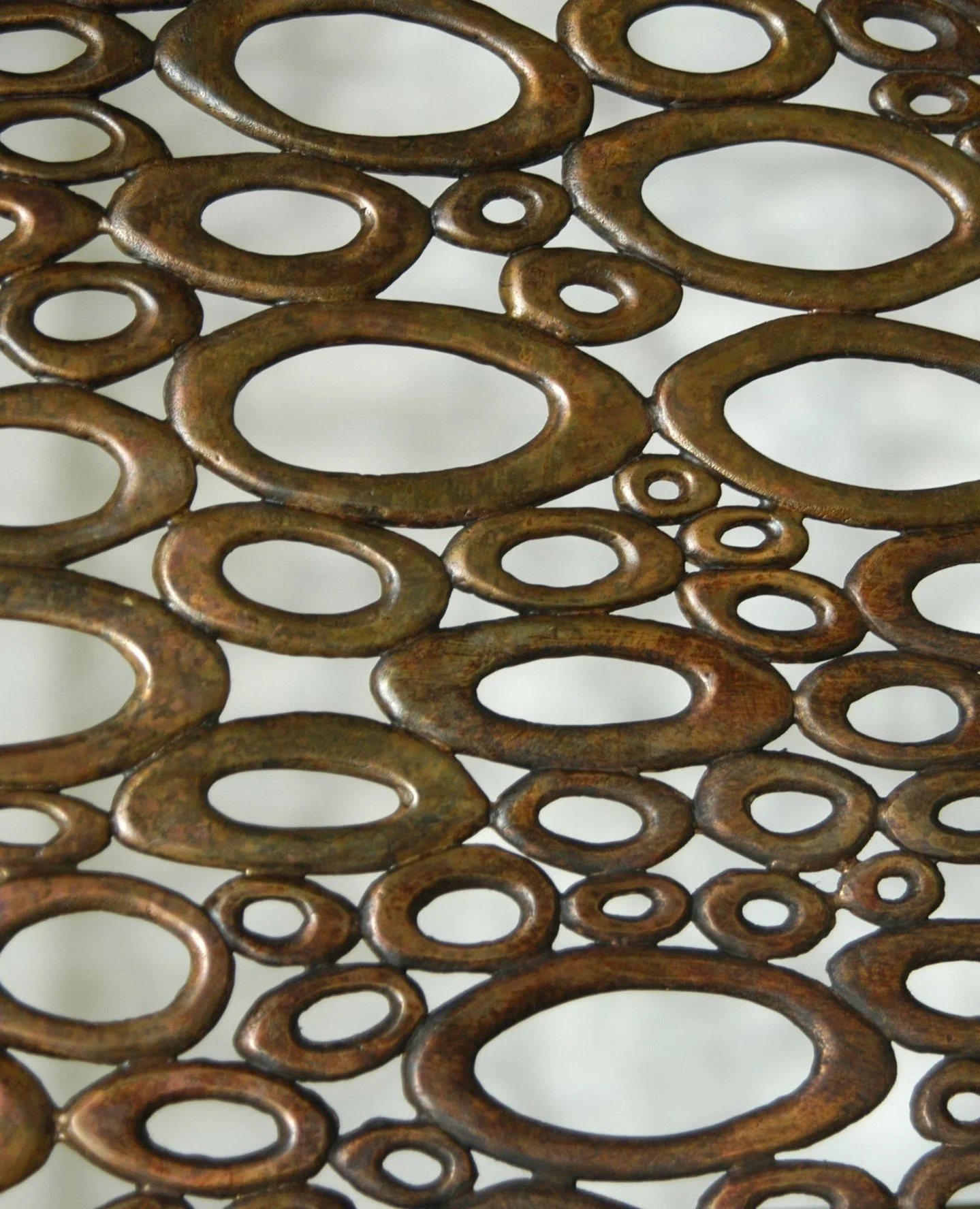 Detail from a bespoke brass radiator screen made for Caroline Paterson Interior Design. ⁠
⁠
Small section of ovals constructed like a jigsaw puzzle.  Our highly skilled team of metal workers were extremely busy.⁠
⁠