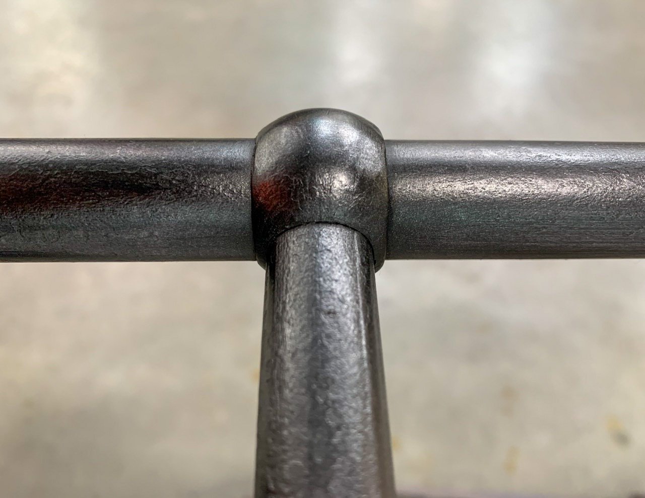 Close-up shot of bed posts in blackened steel finish